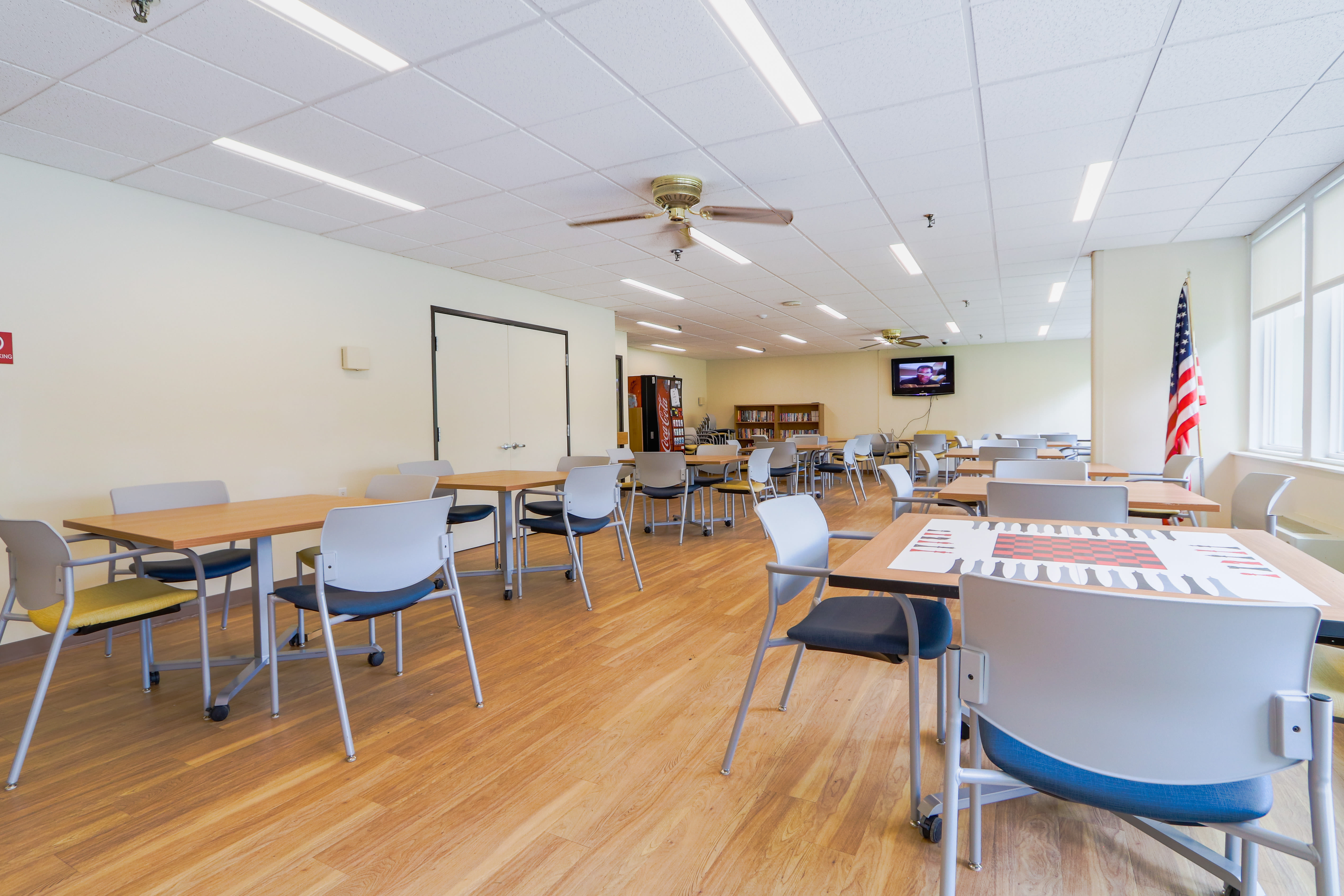Community room with tables at Autumn Ridge Village in Sterling Heights, Michigan