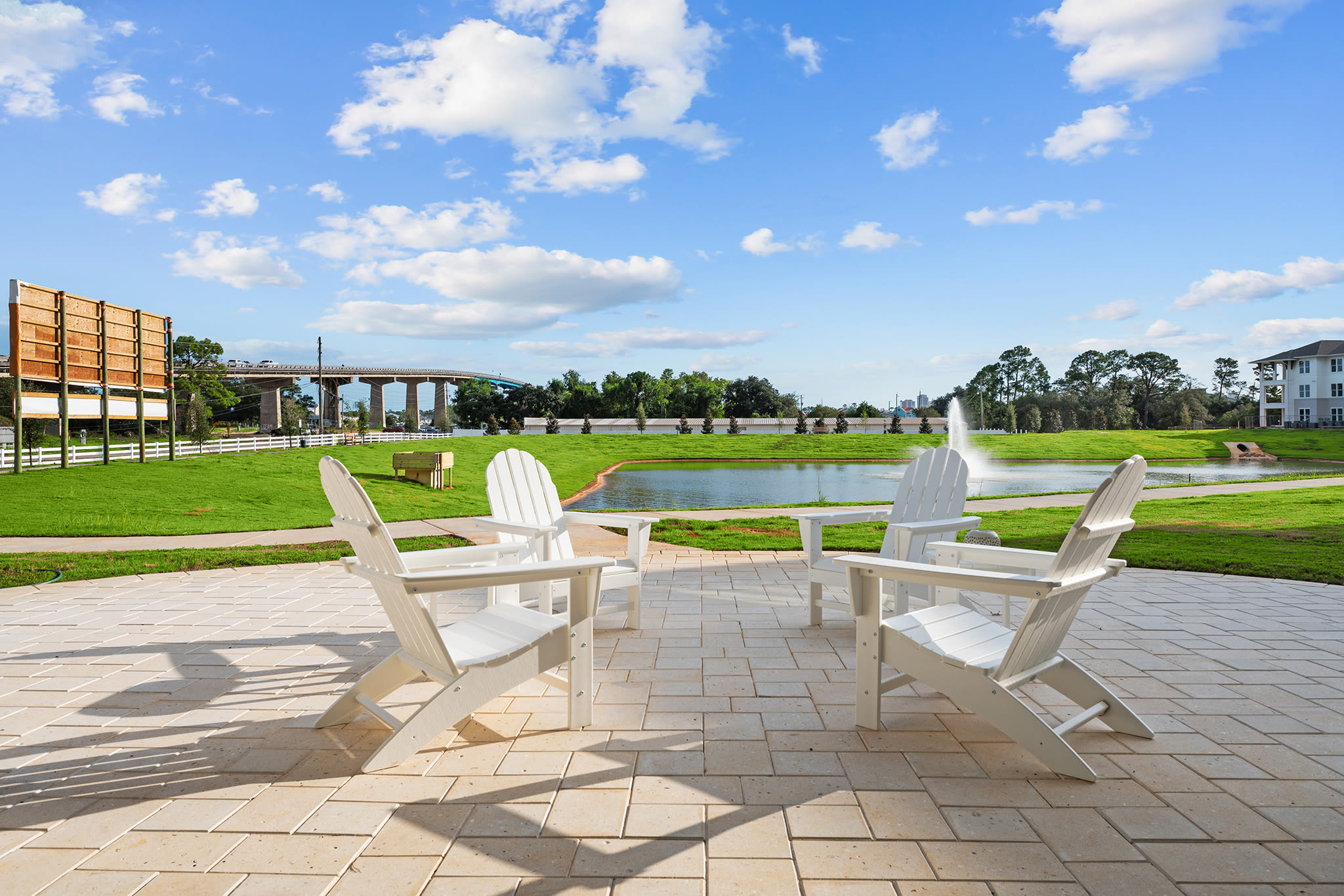 Lounge chairs near the pond at Altura | Apartments & Townhomes in Pensacola, Florida