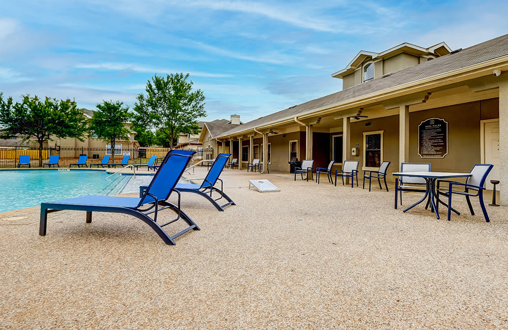 Swimming pool sundeck at Legacy of Cedar Hill Apartments & Townhomes in Cedar Hill, Texas.