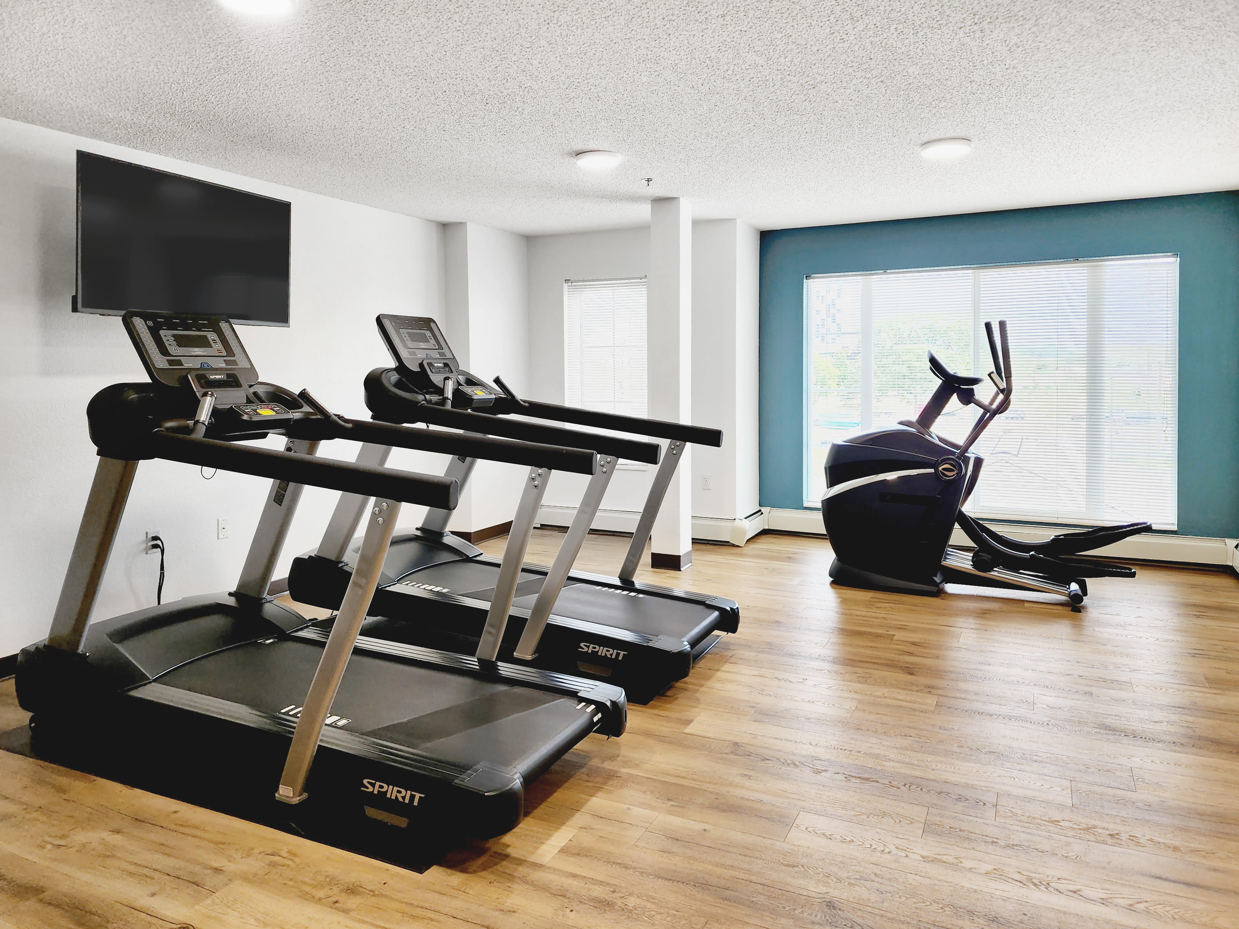 A fitness center with a large window at Parkway Gardens Senior Apartment Community in Saint Paul, Minnesota