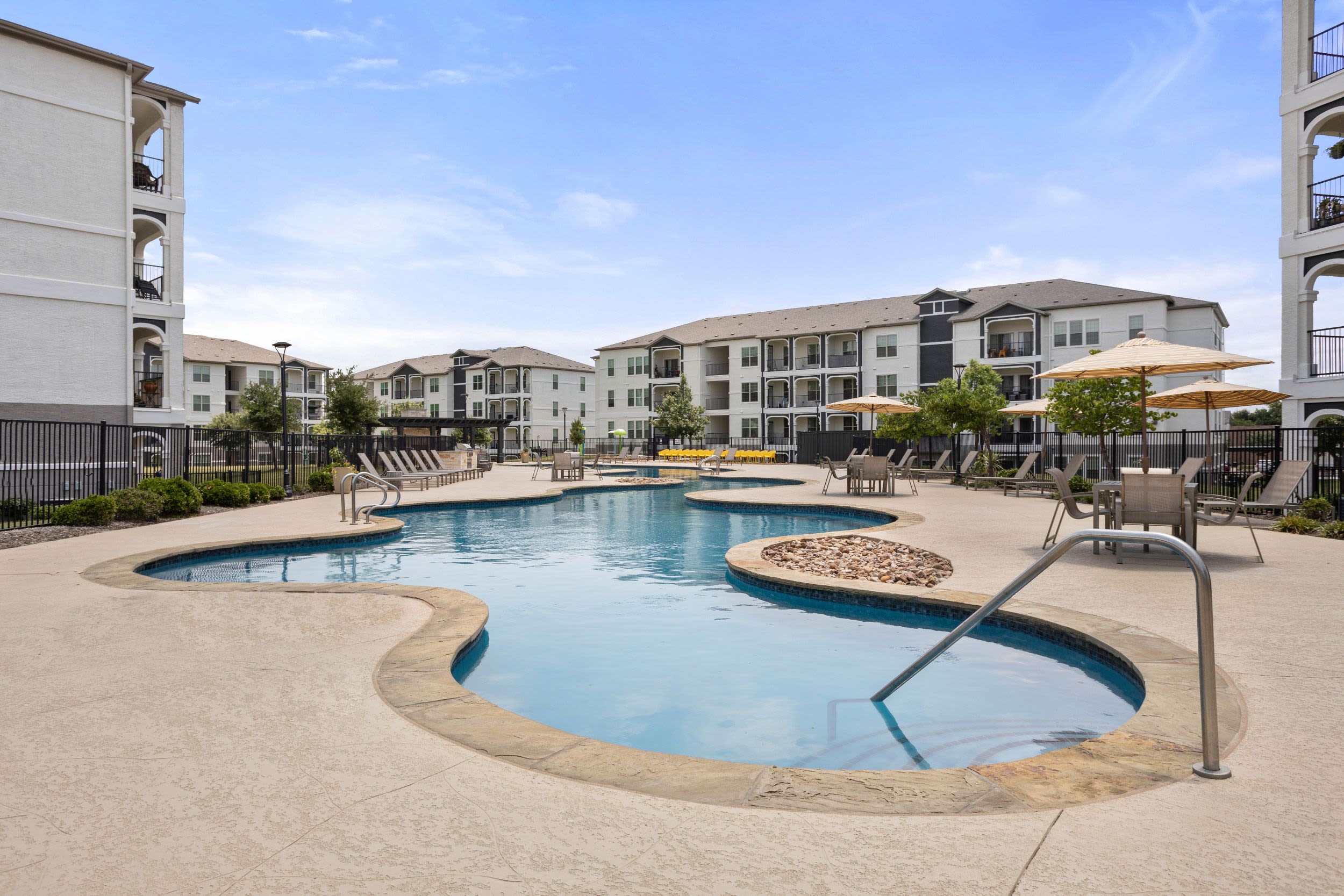Resort-style swimming pool on another beautiful day at Olympus Woodbridge in Sachse, Texas