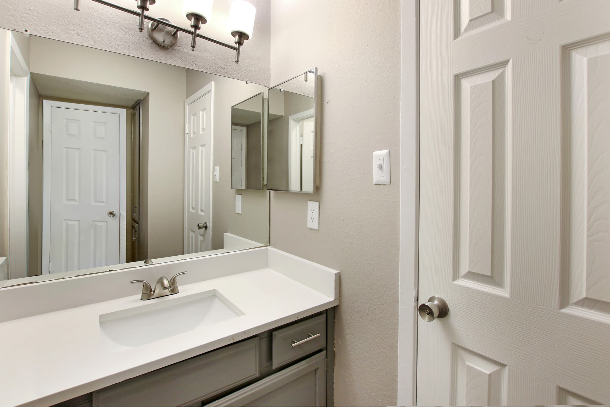 Bathroom with nice countertop at Fiona Apartment Homes in Irving, Texas