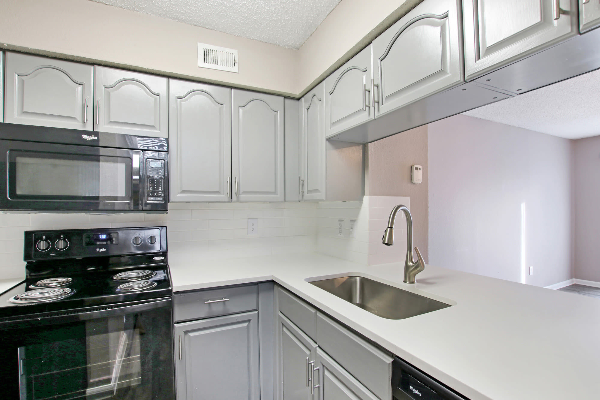 Kitchen with modern backsplash at Fiona Apartment Homes in Irving, Texas