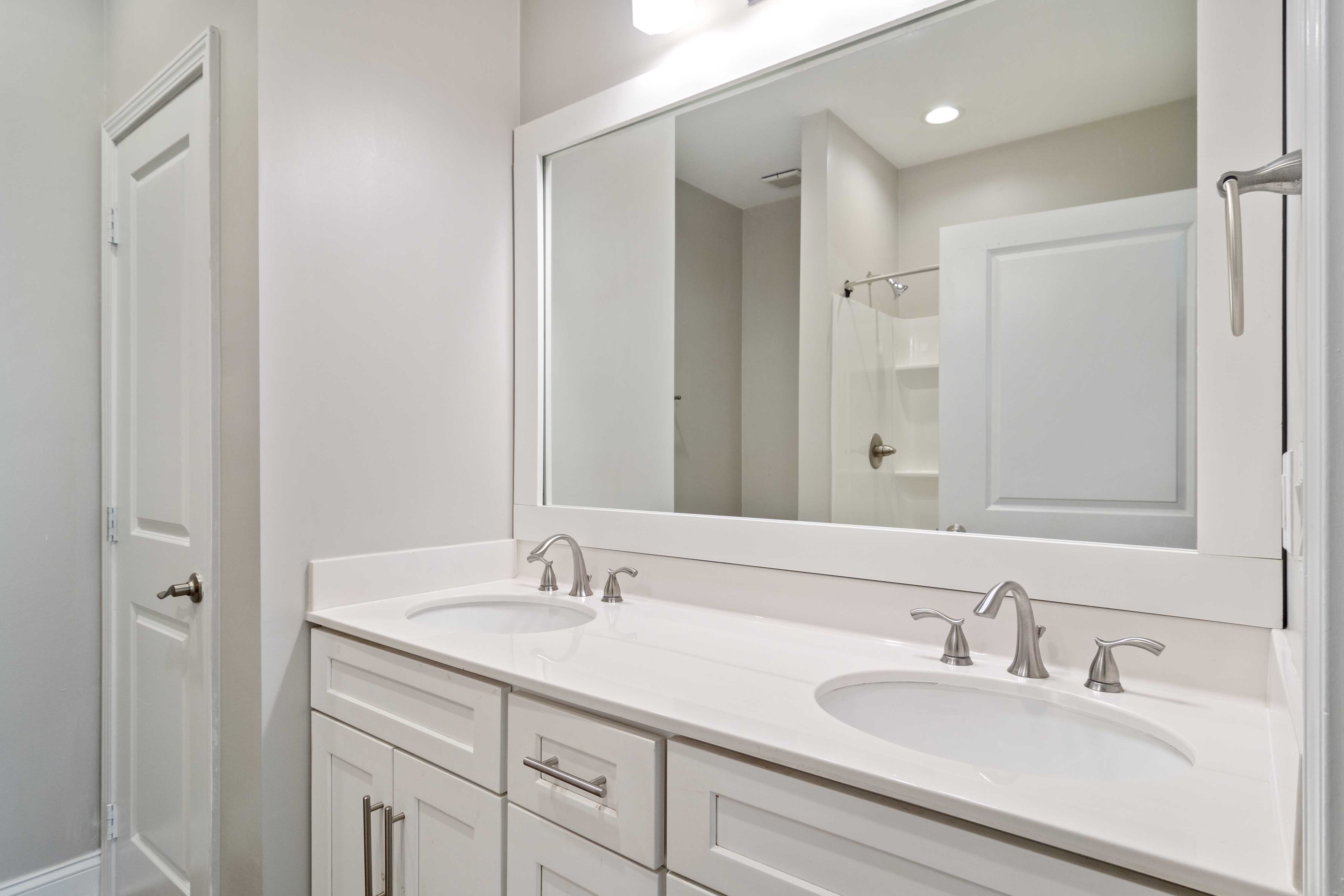 An apartment bathroom with two sinks at Mirador at Peachtree in Atlanta, Georgia