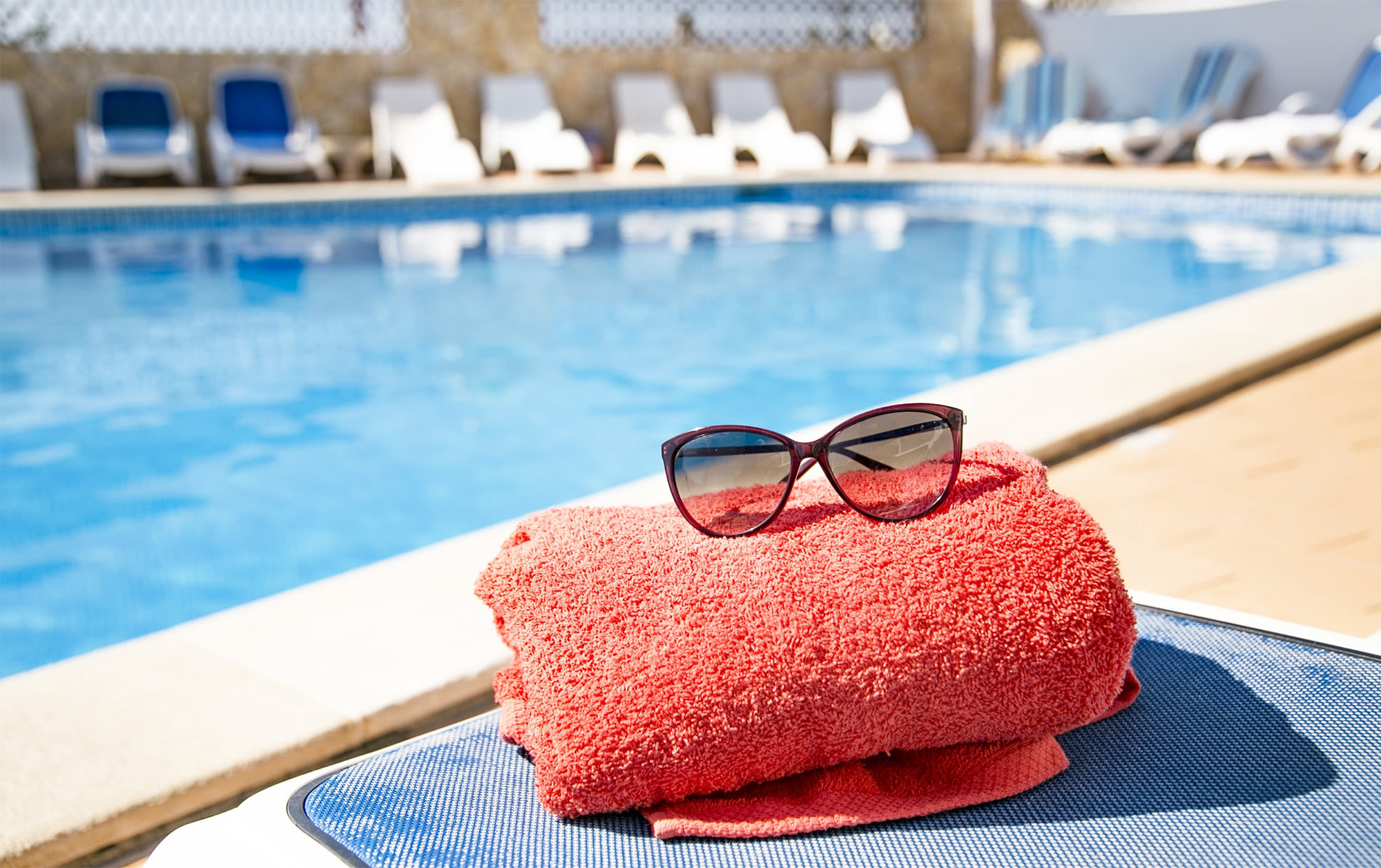 Sunglasses and towel by the pool at The 603 in Bryan, Texas