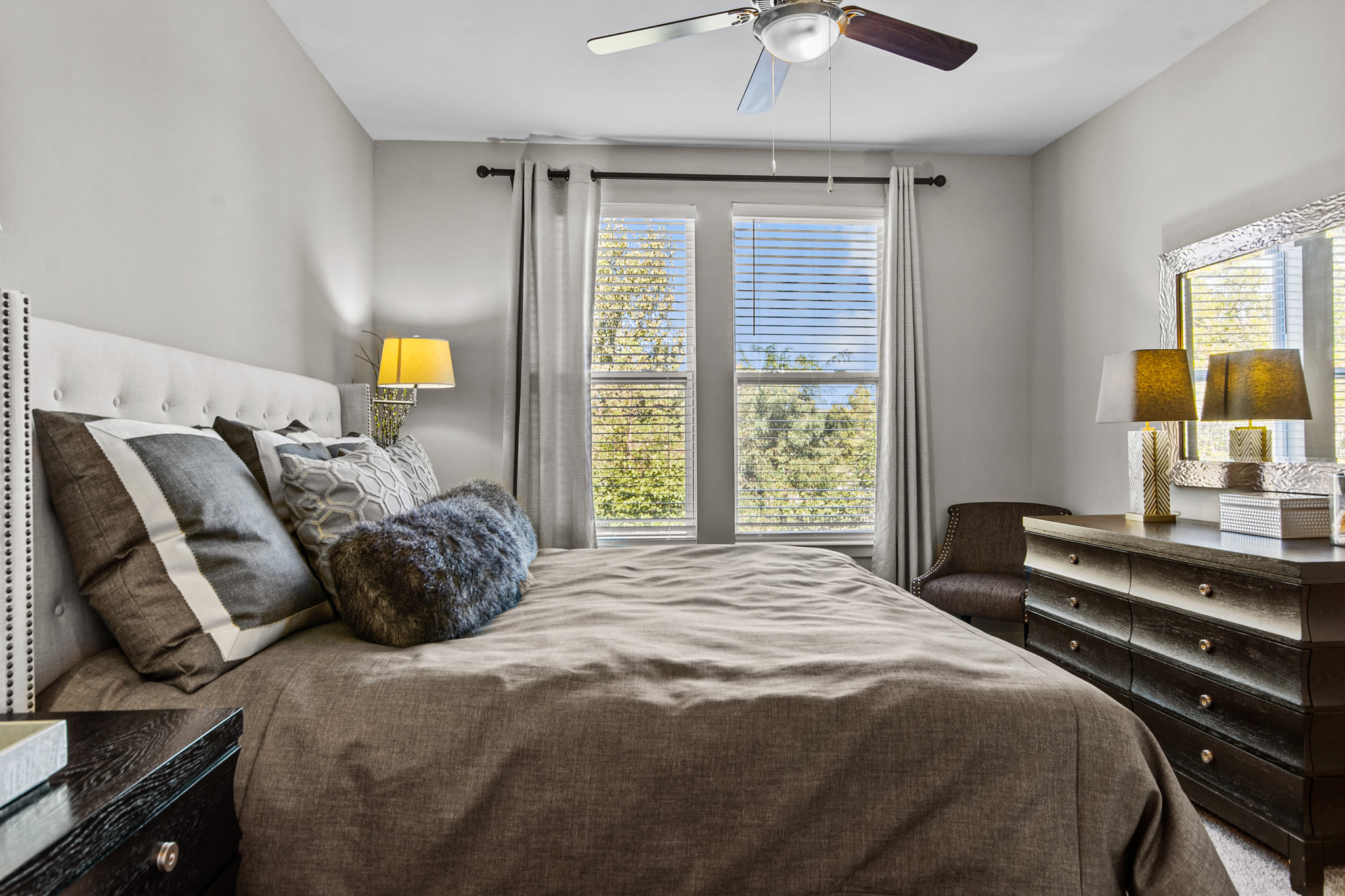 Model bedroom with plush carpeting and a ceiling fan at Artessa in Franklin, Tennessee