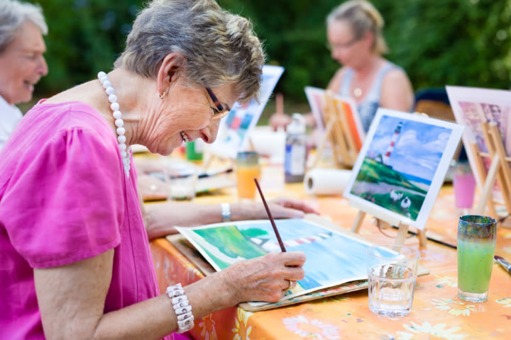 Resident painting at an easel at Vista Prairie Communities in Champlin, Minnesota