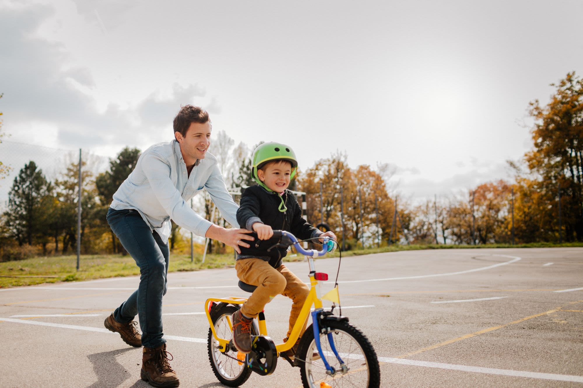 Resident helping their kid learn how to bike near Waterford Place in Folsom, California