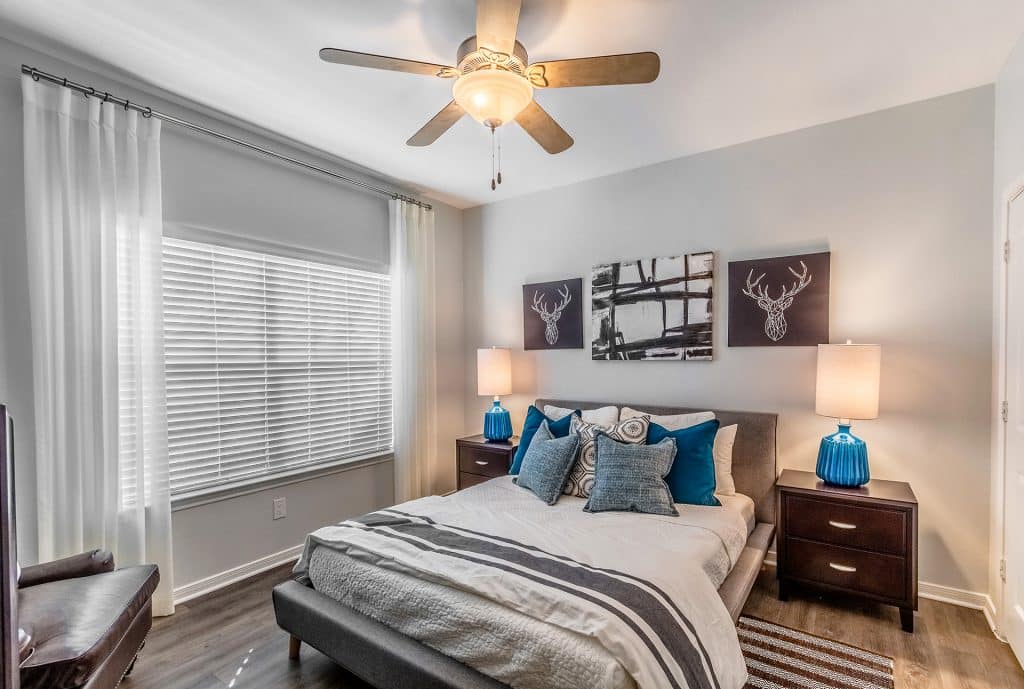 Modern bedroom with a ceiling fan and a nightstand at Urban House in Dallas, Texas