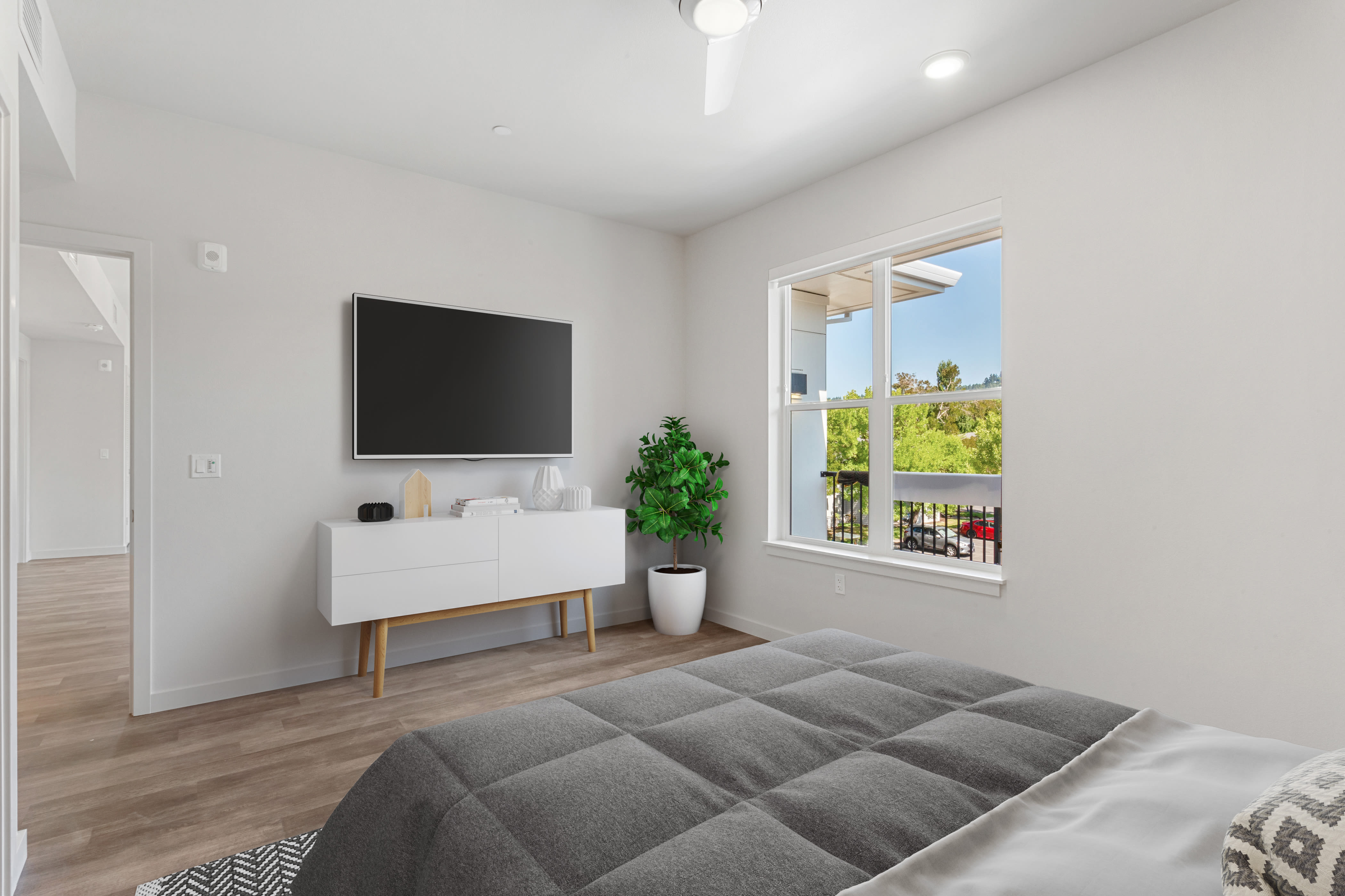 Cozy bedroom with a bright window at Kruseway Commons in Lake Oswego, Oregon