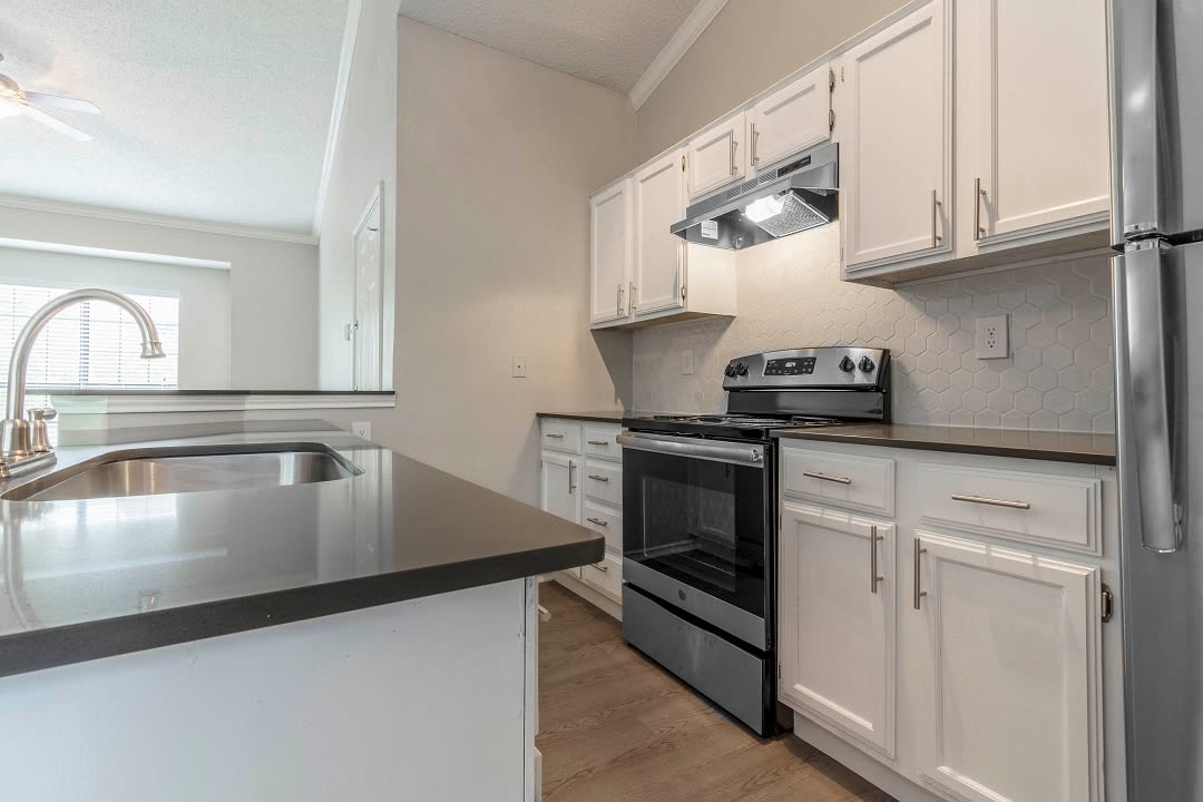 Stainless-steel appliances in an apartment kitchen at Champions of North Dallas in Dallas, Texas