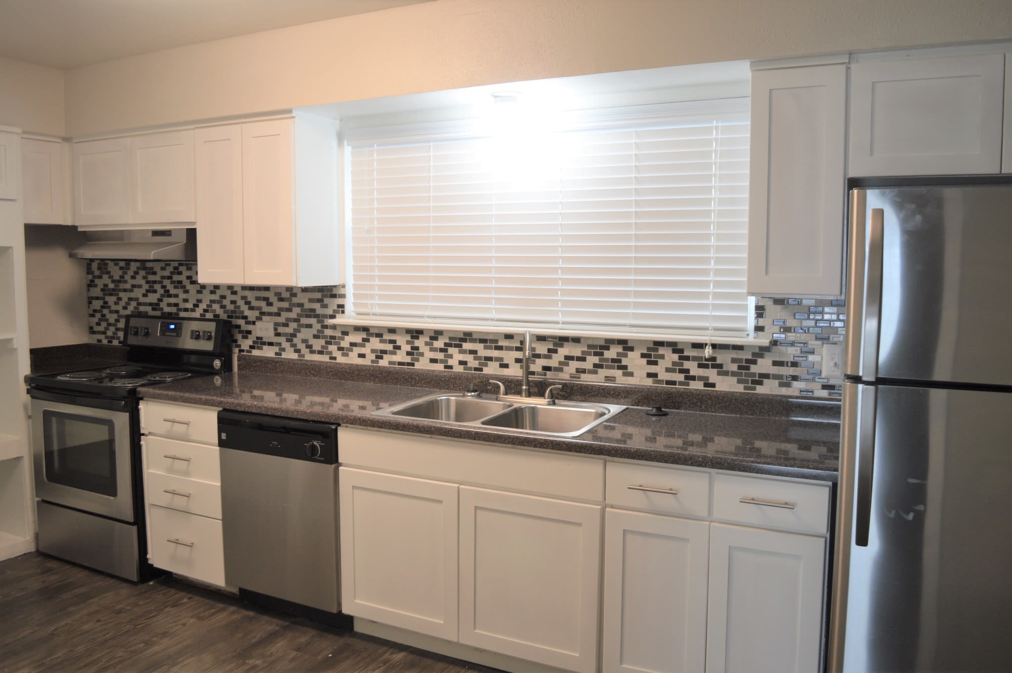 Stainless-steel appliances in an apartment kitchen at Tanglewood in San Antonio, Texas