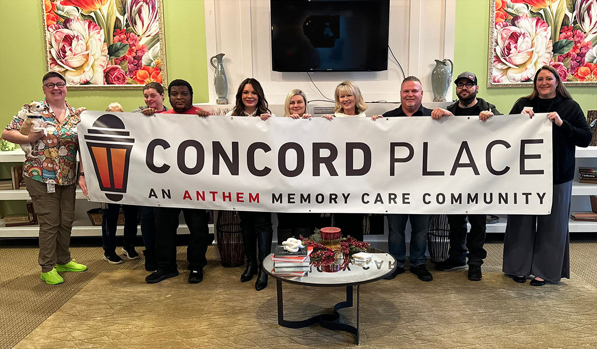 Team holding banner for Concord Place