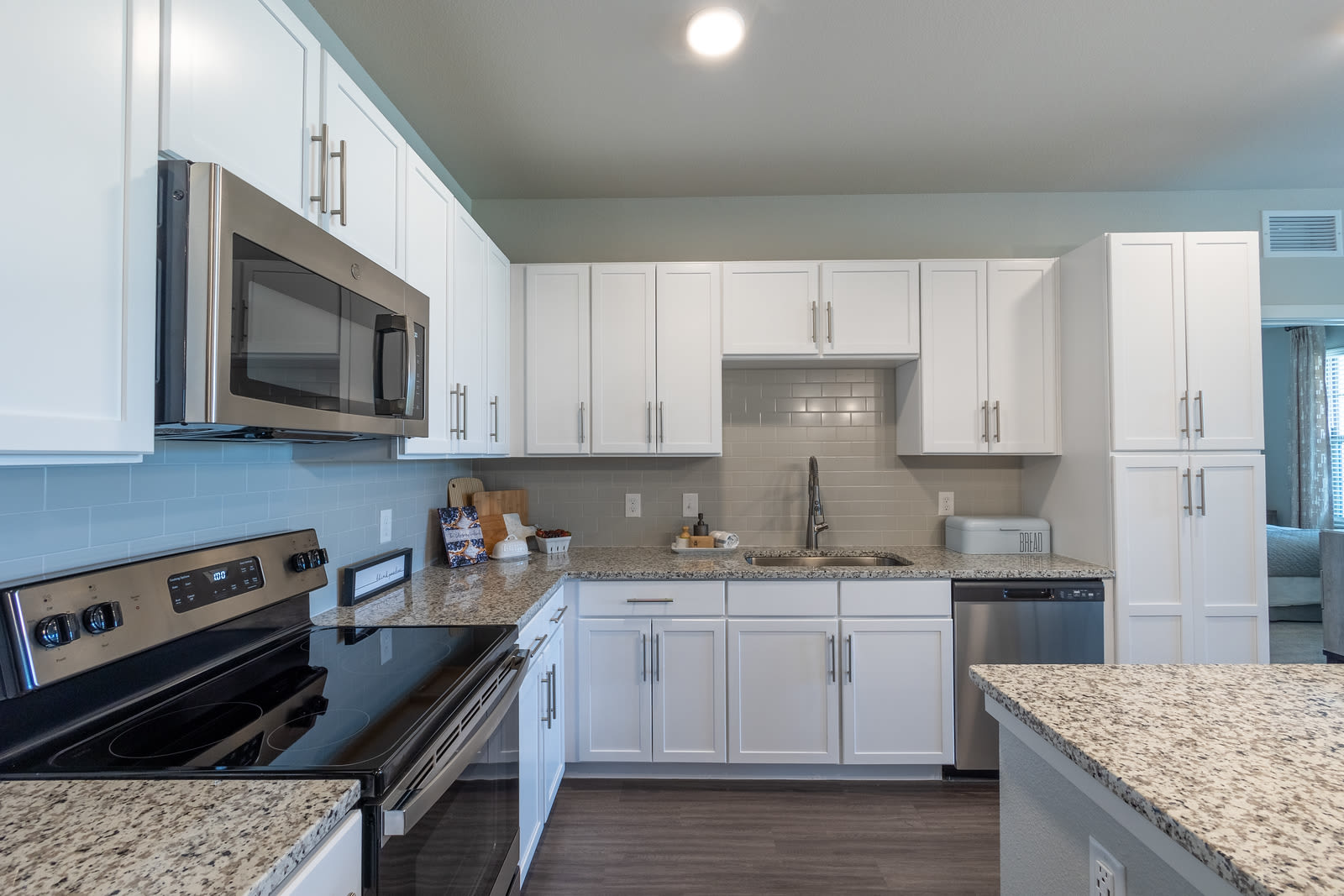Fully furnished kitchen with granite countertops at Indigo Champions Ridge in Davenport, Florida