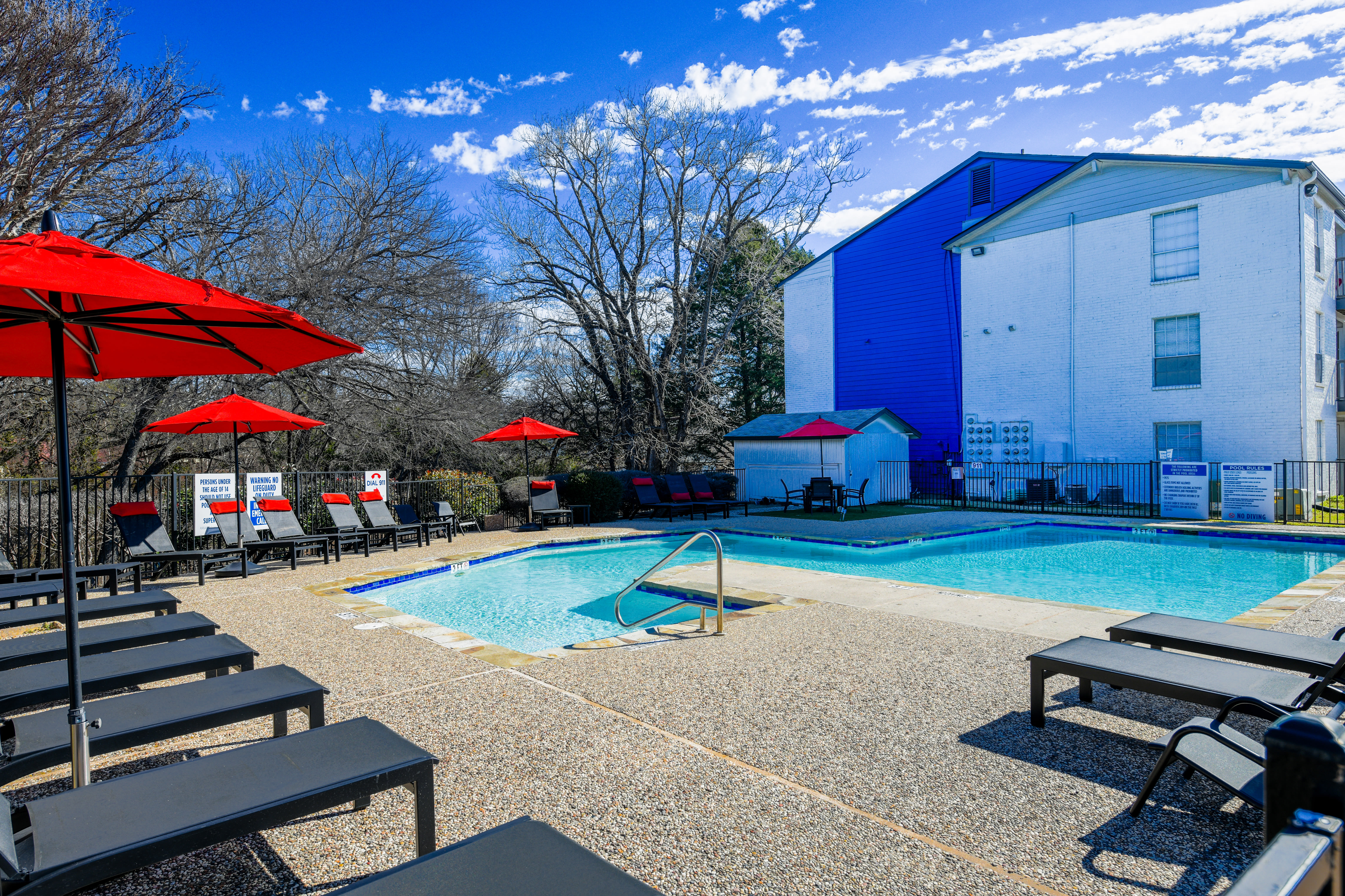 Pool view and red umbrellas at The Broadway in Garland, Texas
