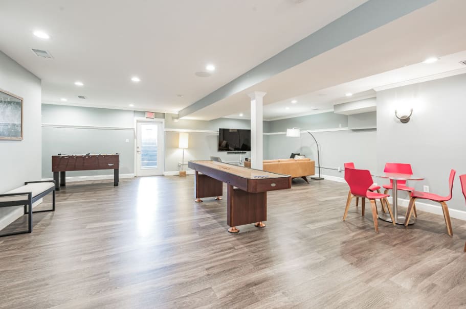 Modern recreation room with billiards table and seating area at  Summit at Mill Ridge