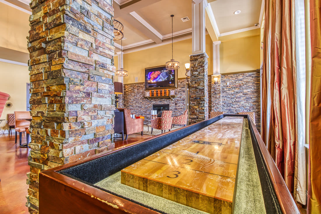 Game room and residence lounge with shuffleboard and flat screen TV at Glass Creek in Mt Juliet, Tennessee