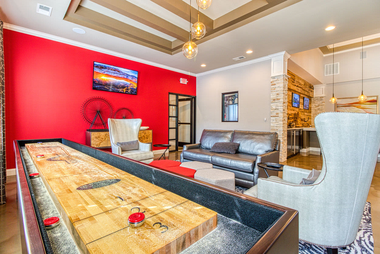 Game room with shuffleboard and entertainment area at Greymont Village in Asheville, North Carolina