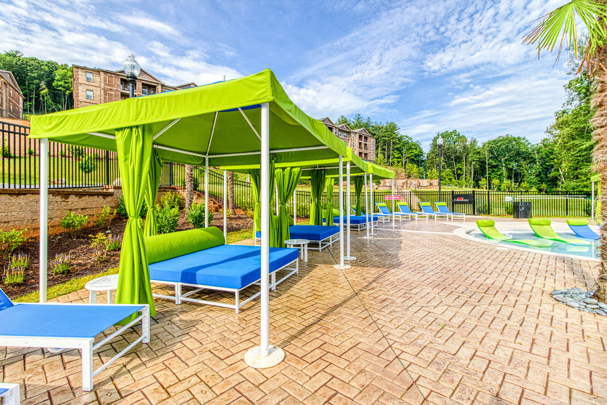 Canopies and chaise lounge chairs on the tanning sundeck surrounding the pool at Greymont Village in Asheville, North Carolina