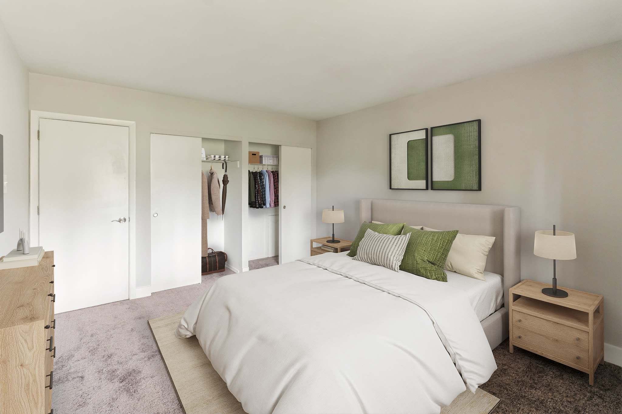 Naturally Well Lit Bedroom Area with green accent pillows and paintings at Eagle Rock Apartments at Malvern in Malvern, Pennsylvania