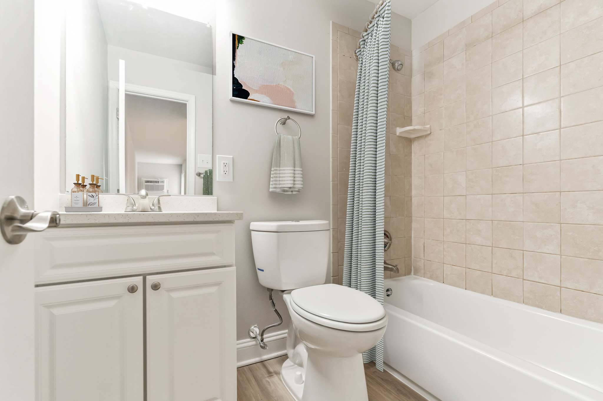 White Bathroom with toiler and bathtub at Eagle Rock Apartments at Malvern in Malvern, Pennsylvania 
