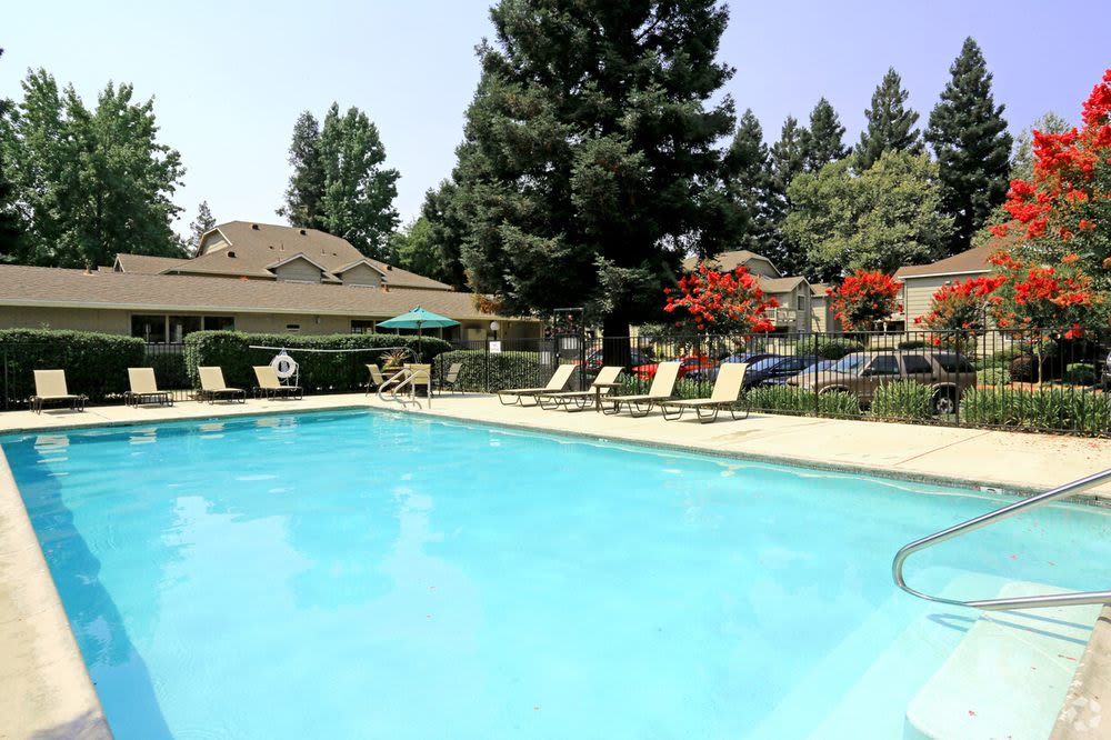 Swimming pool with deck chairs at  River Terrace in Sacramento, California