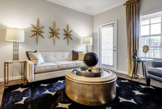 Spacious living room with couch, coffee table and access to patio through french door with glass window at Maystone at Wakefield in Raleigh, North Carolina