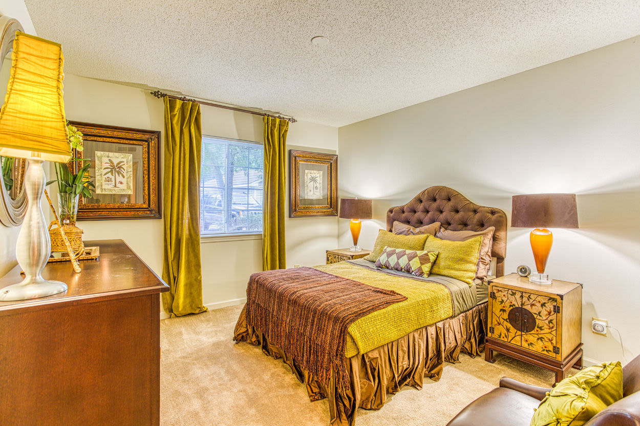 Spacious bedroom with connecting bathroom, plush carpeting, and large closets at Brannigan Village in Winston Salem, North Carolina
