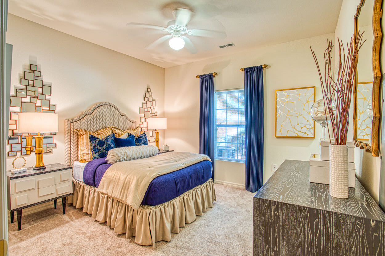 Spacious bedroom with large comfortable bed and ceiling fan at Bolton's Landing in Charleston, South Carolina