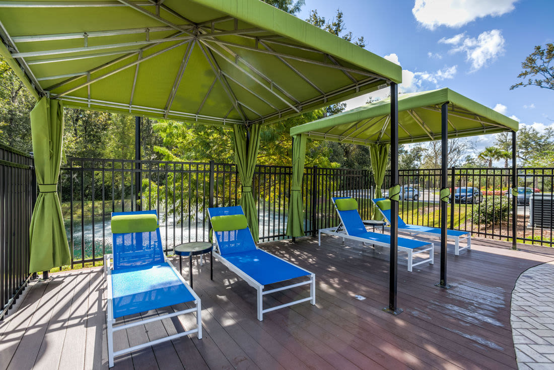 Pool and deck with lounge beds covered by canopies at Kilnsea Village in Summerville, South Carolina