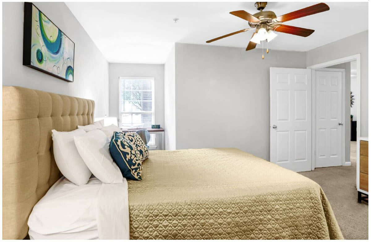 Model bedroom with yellow sheets at Heritage in Hillsborough, North Carolina