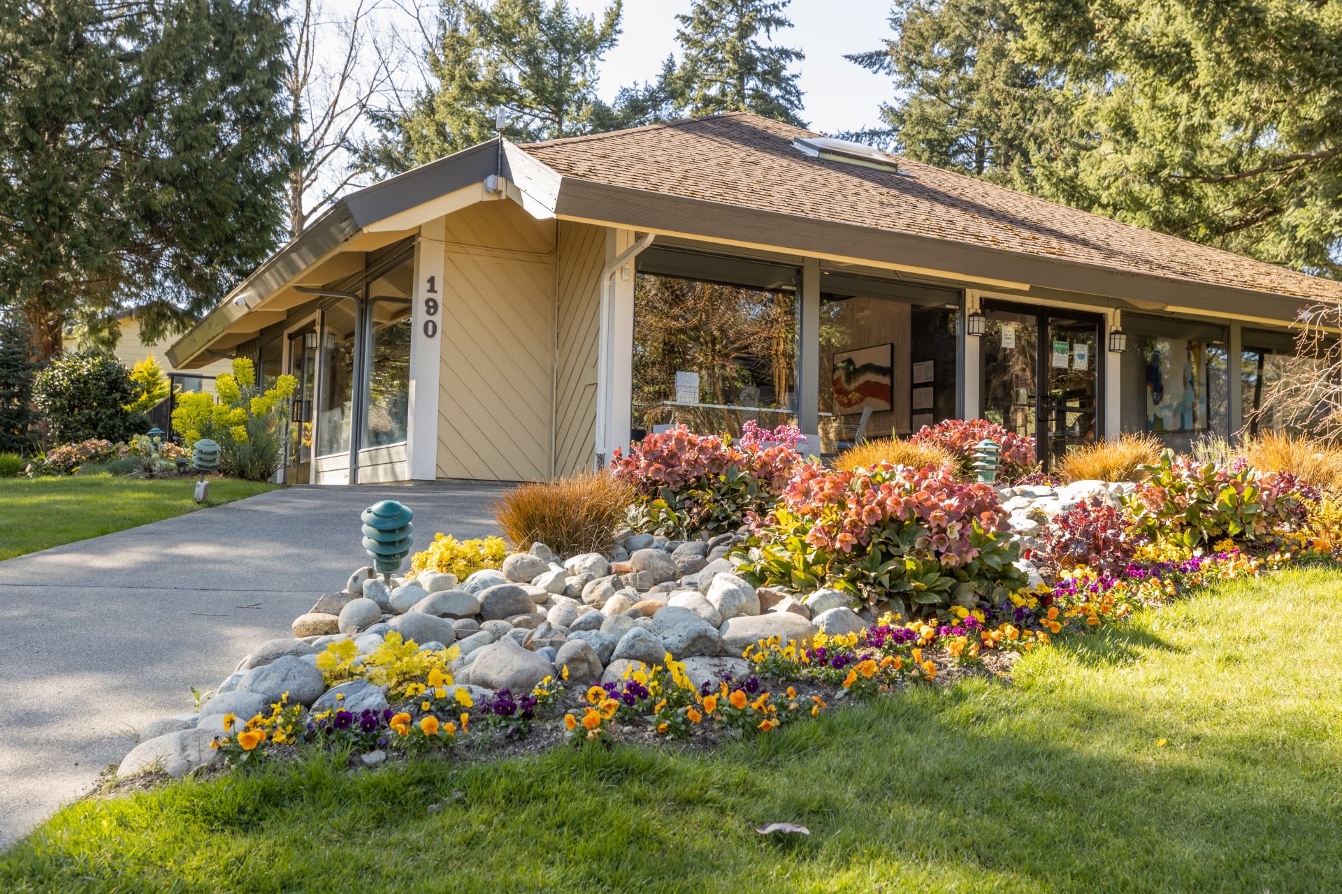 exterior of clubhouse with landscaping at The Commons in Federal Way, Washington