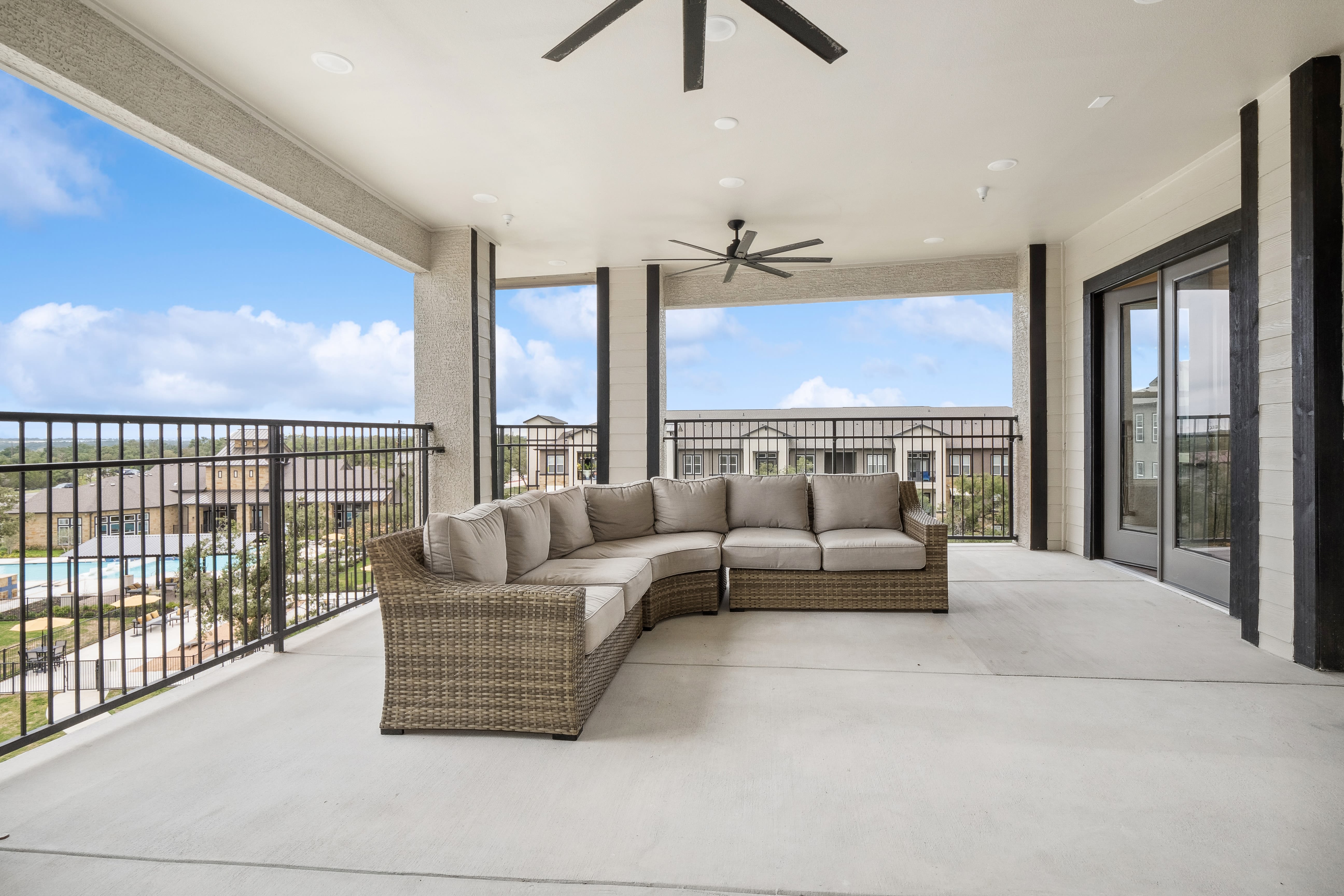 An outdoor sectional couch on a community balcony at Radius Wolf Ranch in Georgetown, Texas