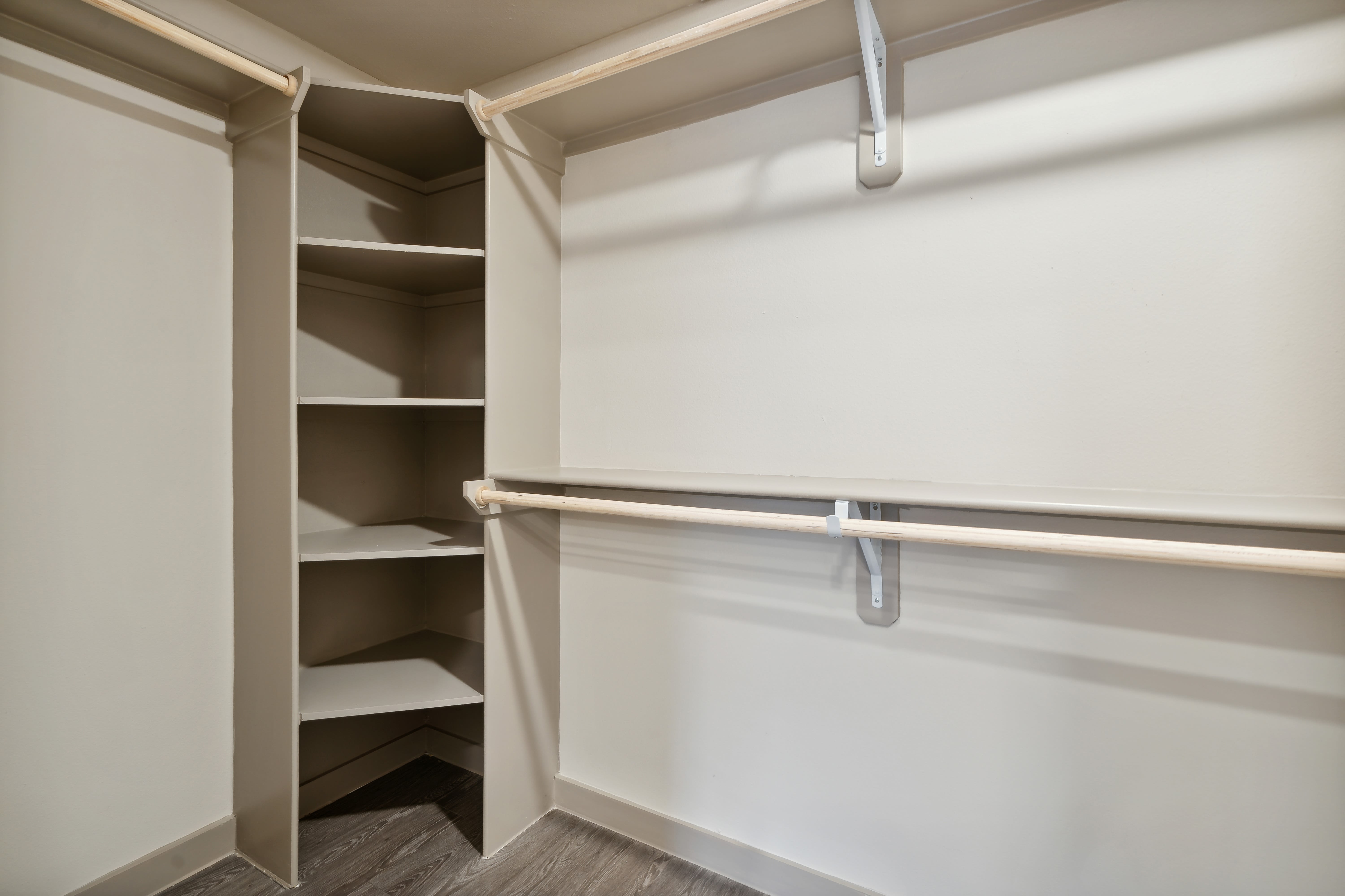 Large walk-in closet with built-in shelves at Radius Wolf Ranch in Georgetown, Texas