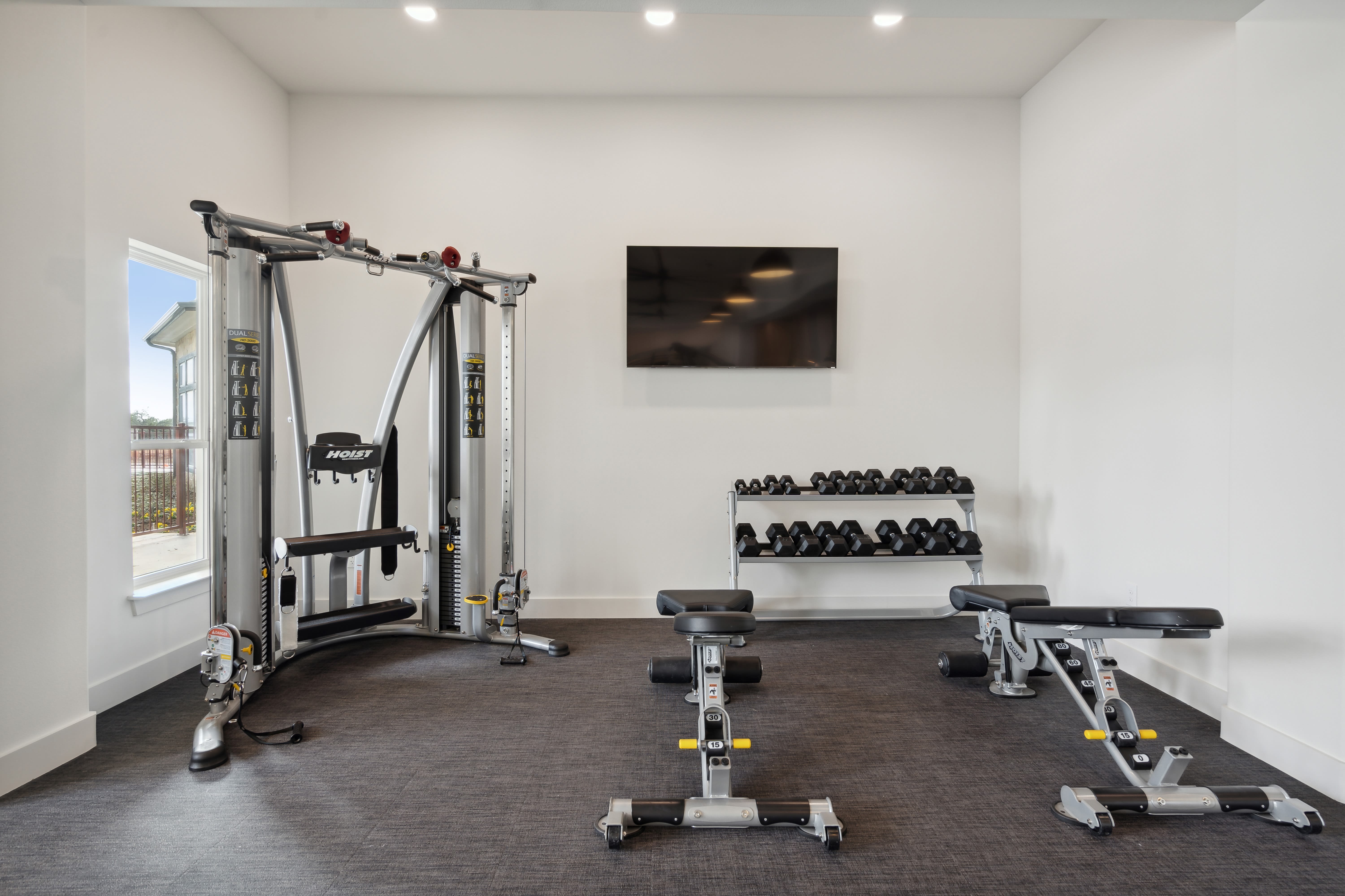 Free weights and weight machines in the fitness center at Radius Wolf Ranch in Georgetown, Texas  