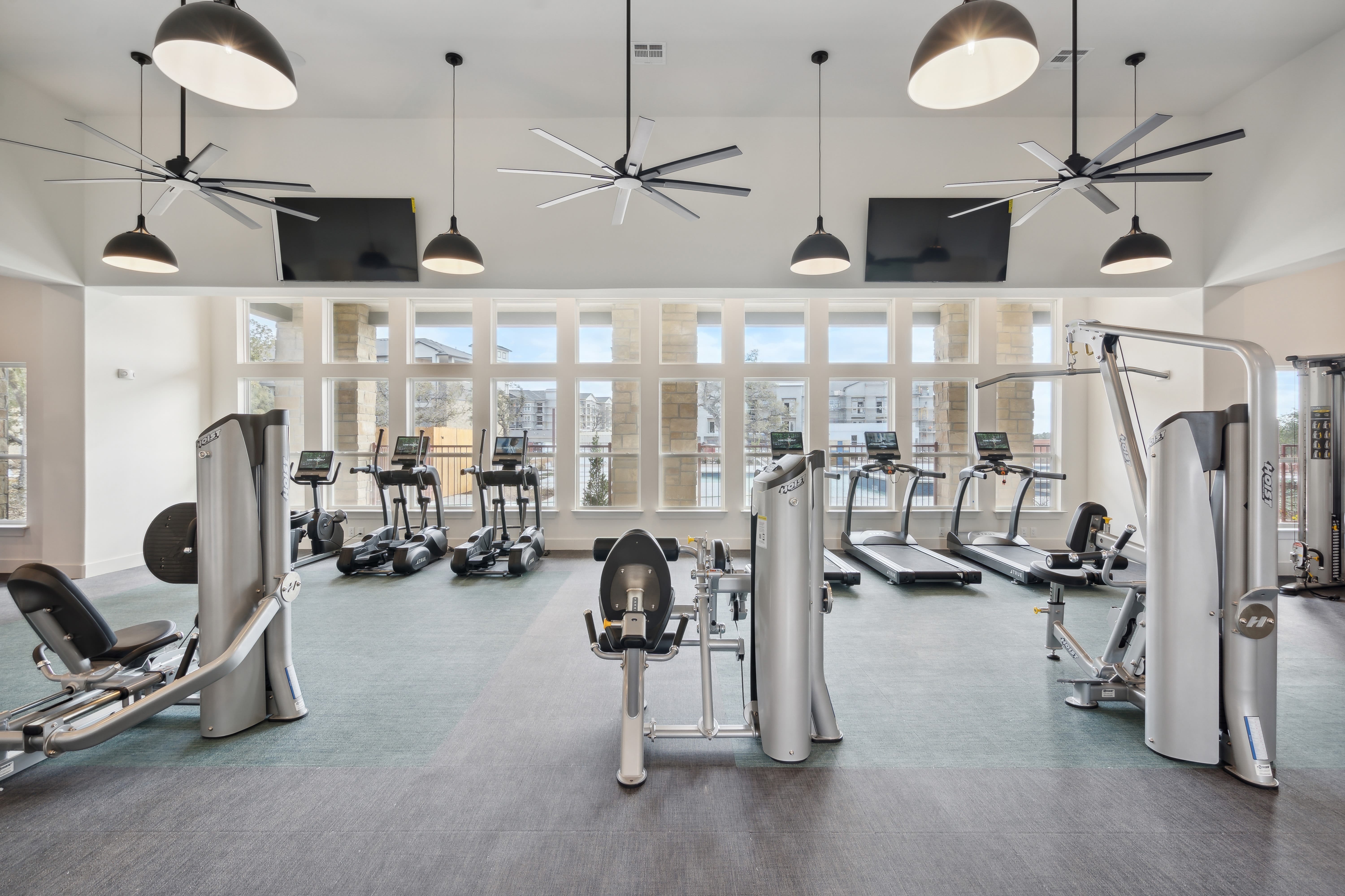 Cardio and weight machines in the fitness center at Radius Wolf Ranch in Georgetown, Texas