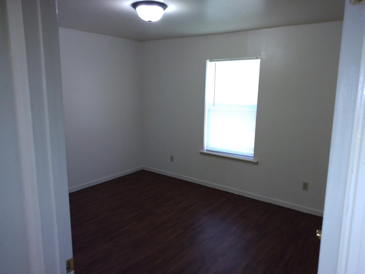 Spacious bedroom with windows at Jasper Manor Apartments in Jasper, Texas