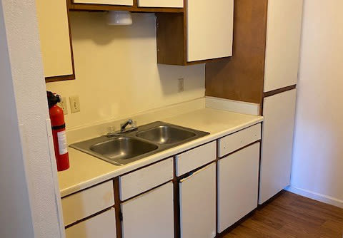 Spacious kitchen with double sink and granite countertop  at Jasper Manor Apartments in Jasper, Texas