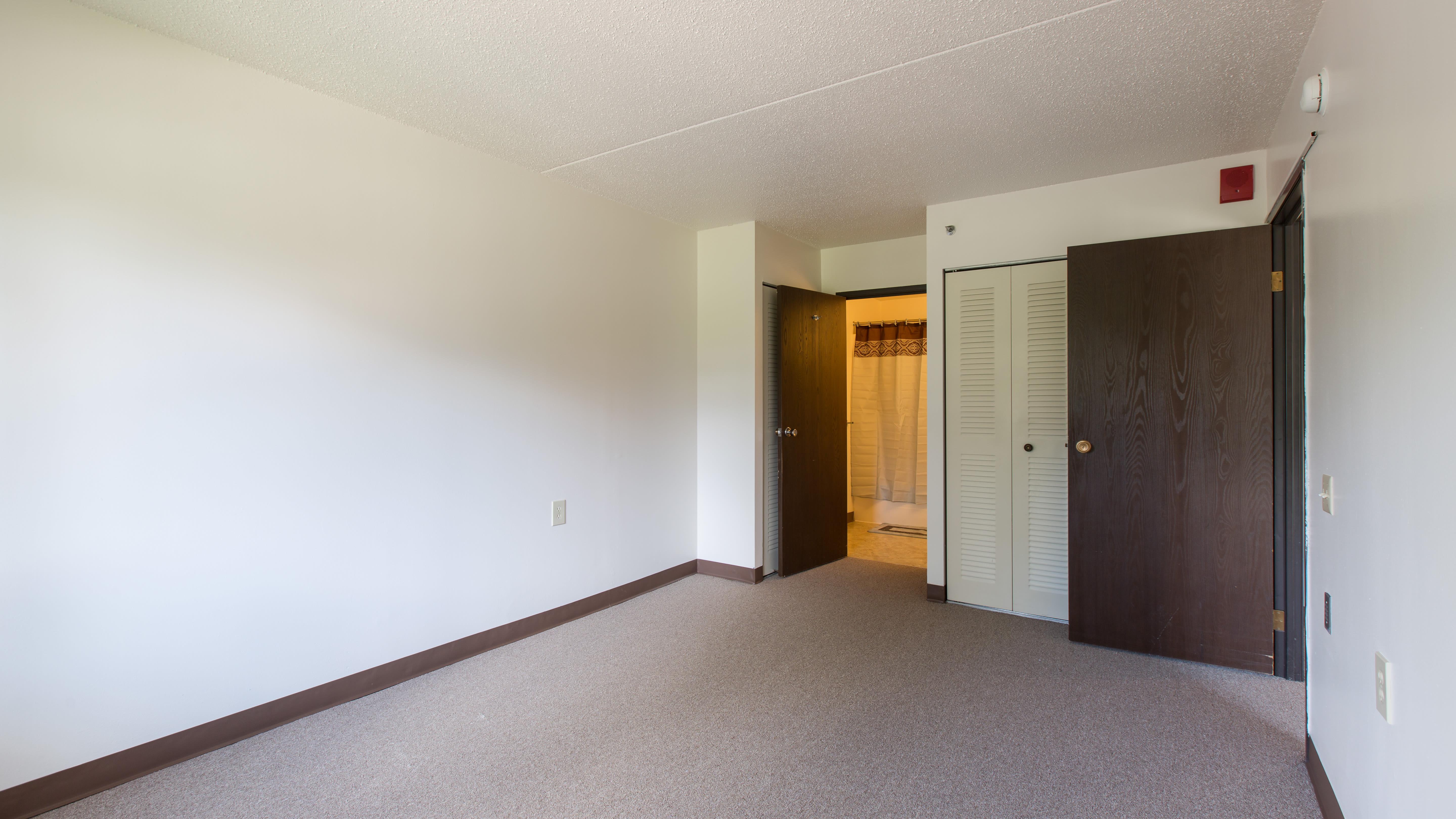 Carpeted bedroom at Ziegler Place in Livonia, Michigan