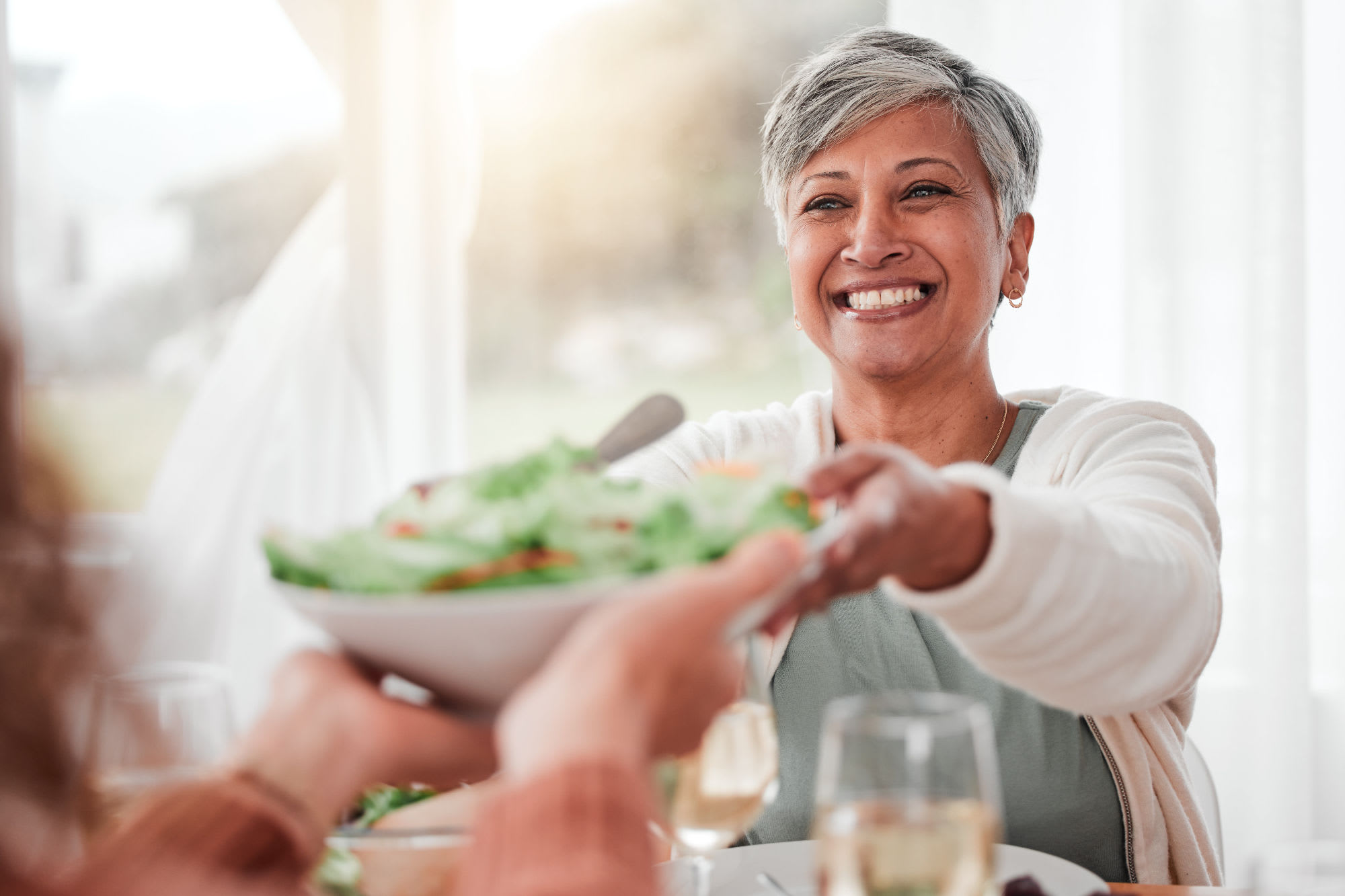 Resident passing a bowl at Haywood Estates in Greenville, South Carolina