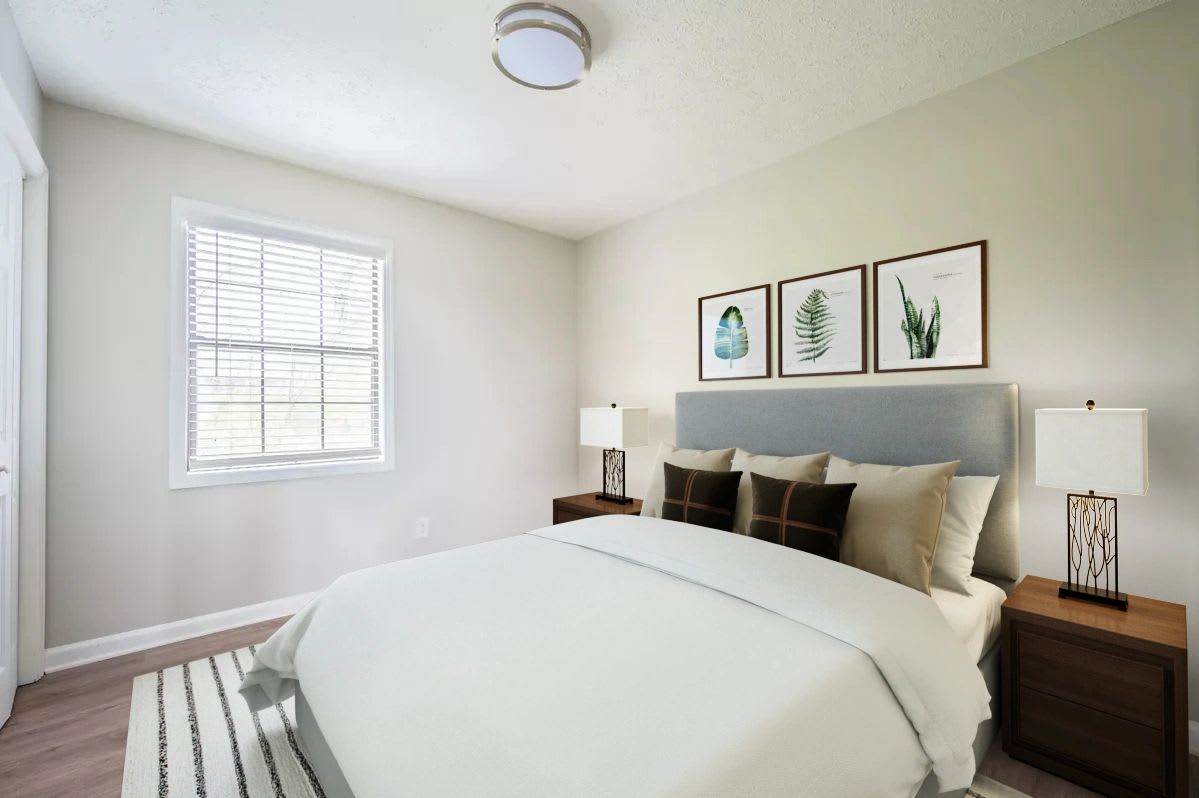 Bedroom with large comfortable bed and windows at Skyline Flats in Nashville, Tennessee