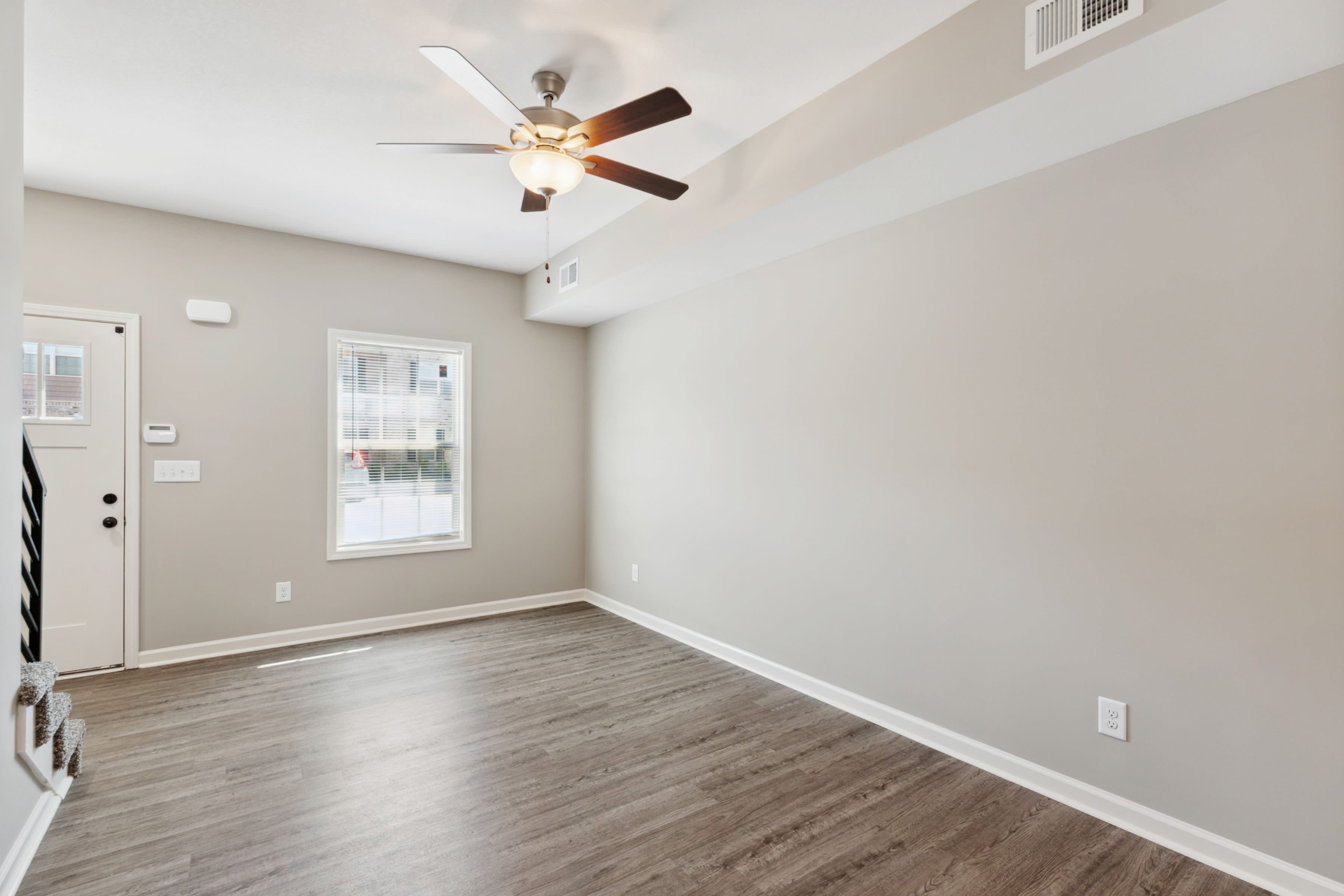 Living room with staircase and window at Parkview Place in Clarksville, Tennessee