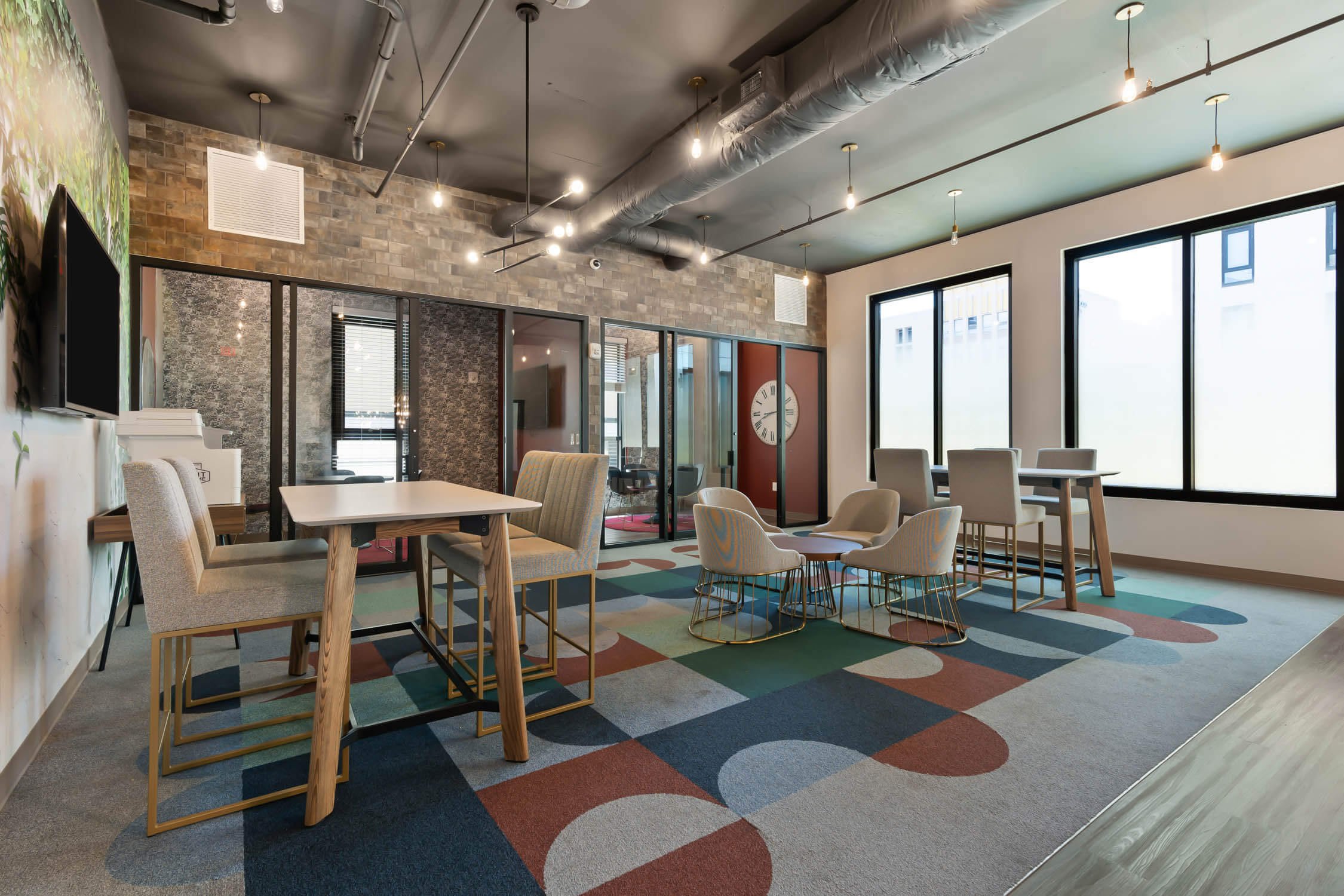 Modern lounge with several chairs and tables at Steelhaven Birmingham in Birmingham, Alabama