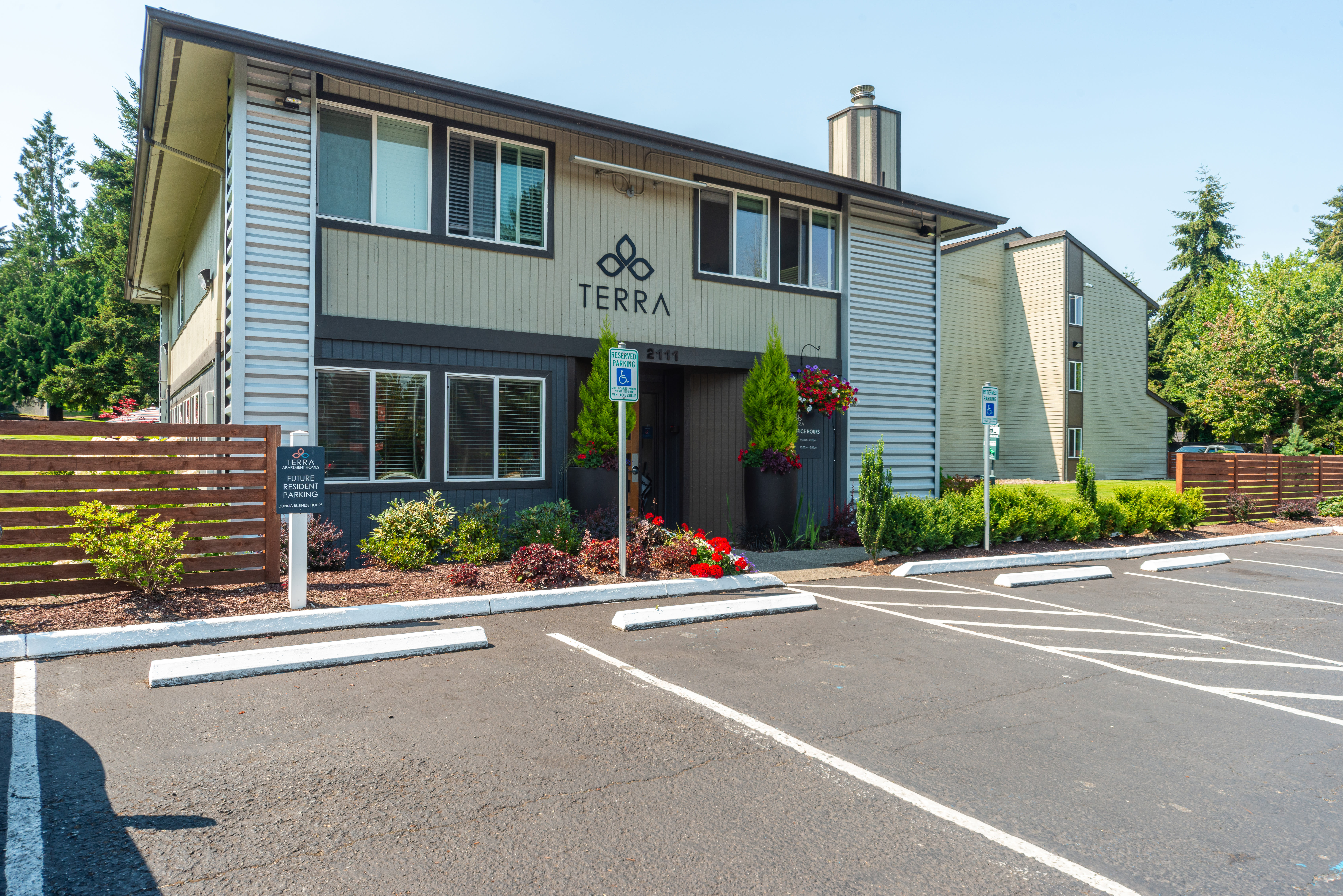 Resident couple checking information on smart phone at Terra Apartment Homes in Federal Way, Washington