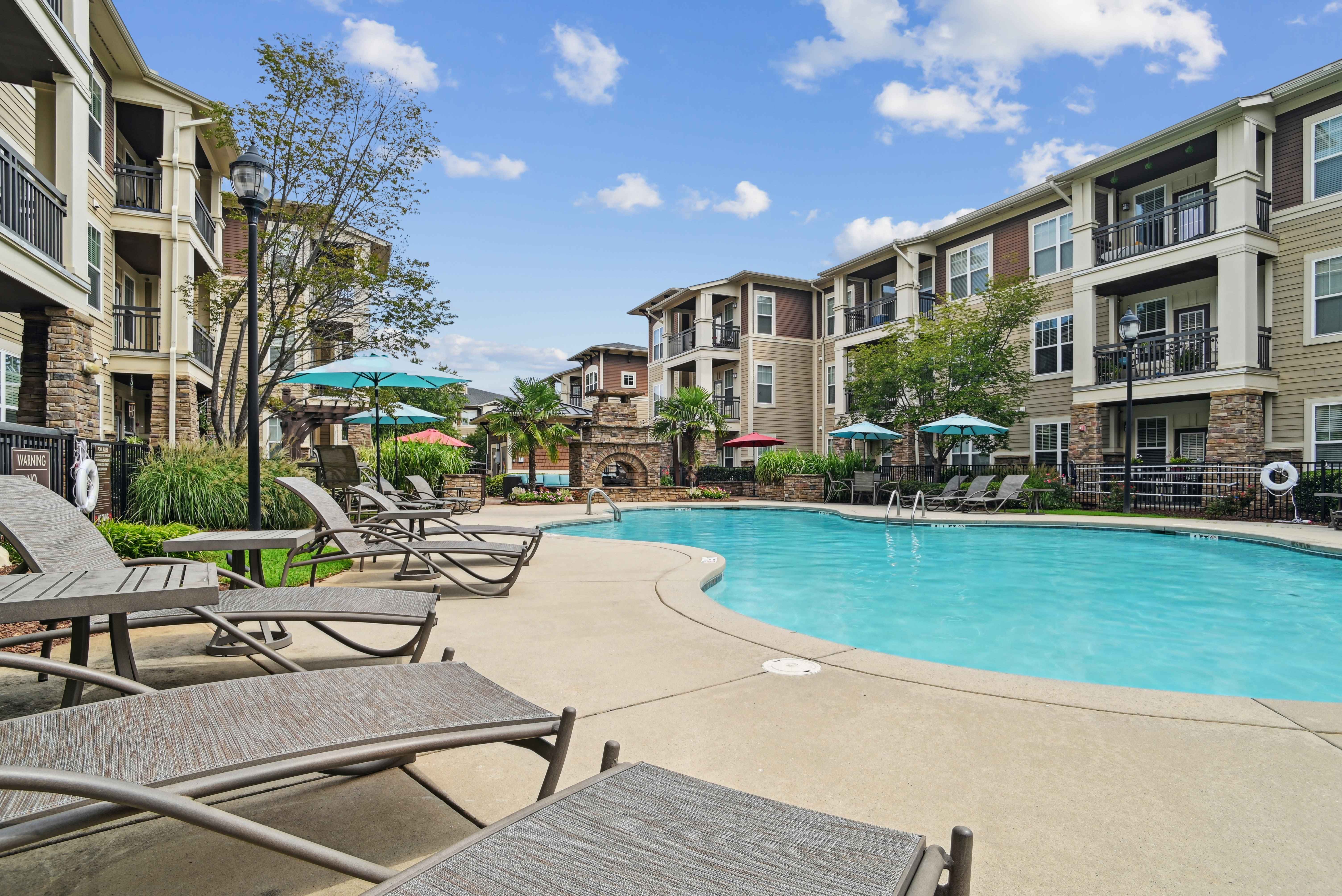 Swimming pool and sun chairs at Fountains at Mooresville Town Square in Mooresville, North Carolina