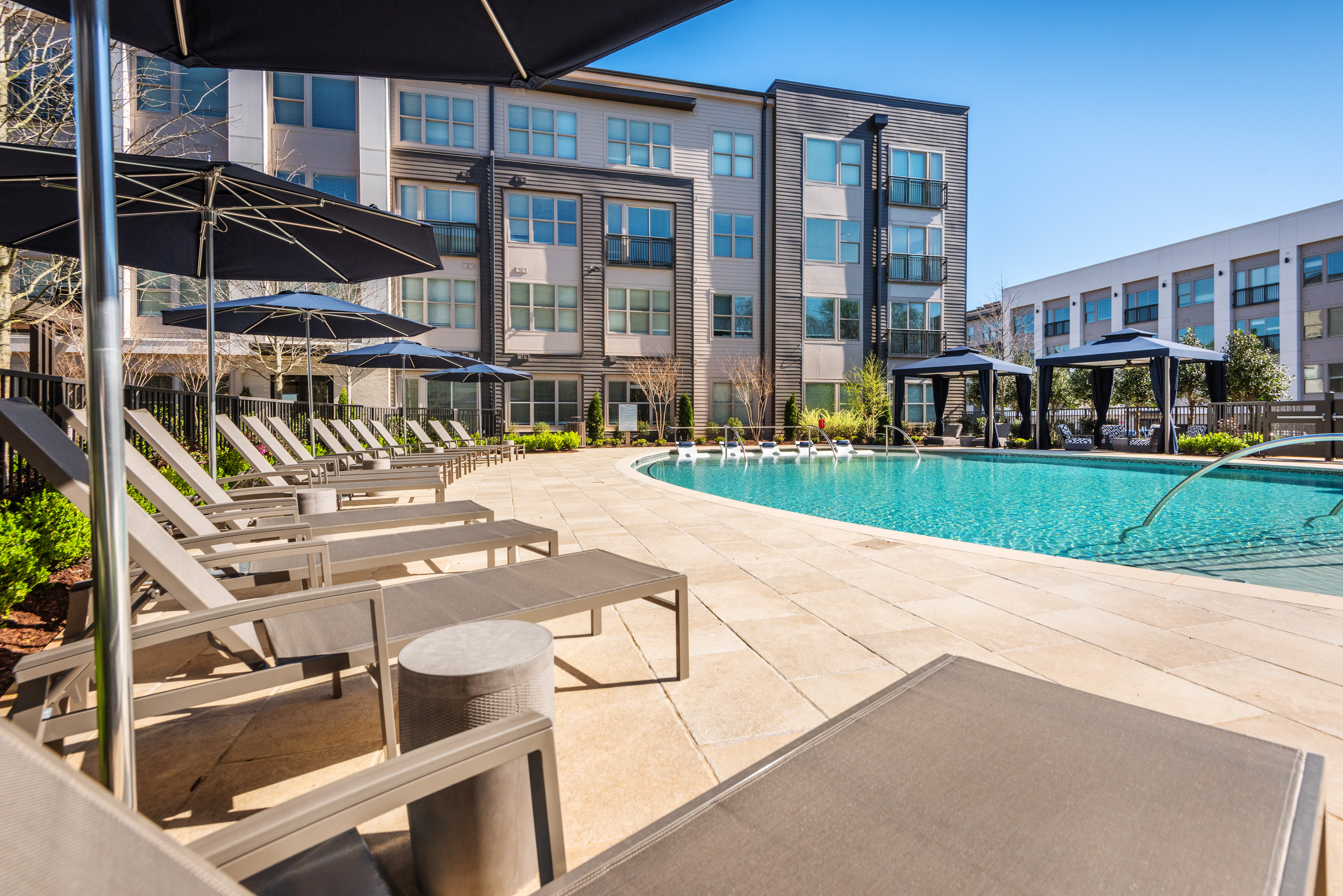 Pool area with lounge seating at The Reverie At Lake Boone in Raleigh, North Carolina