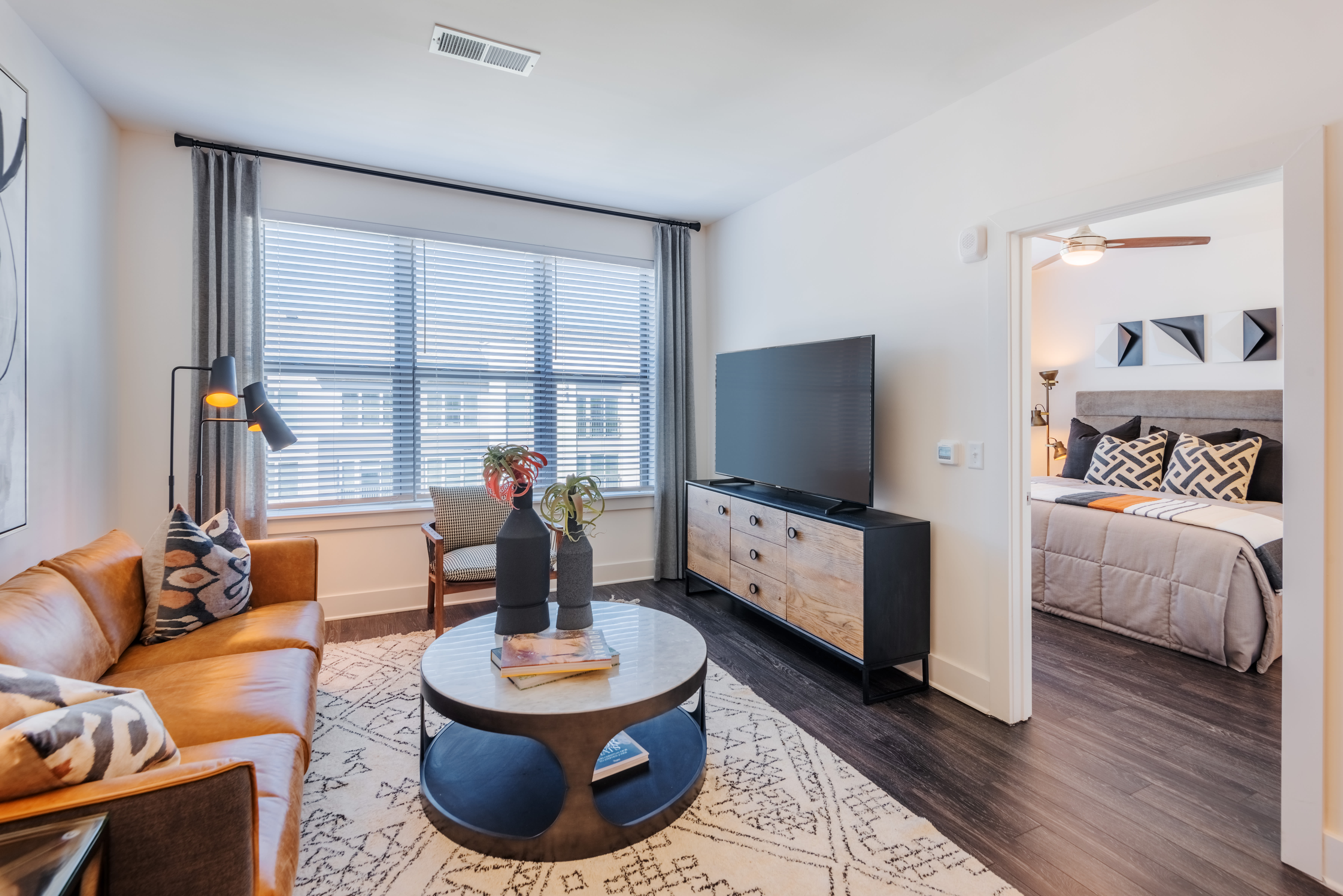Stylish living room with neutral color palette at The Reverie at Lake Boone in Raleigh, North Carolina
