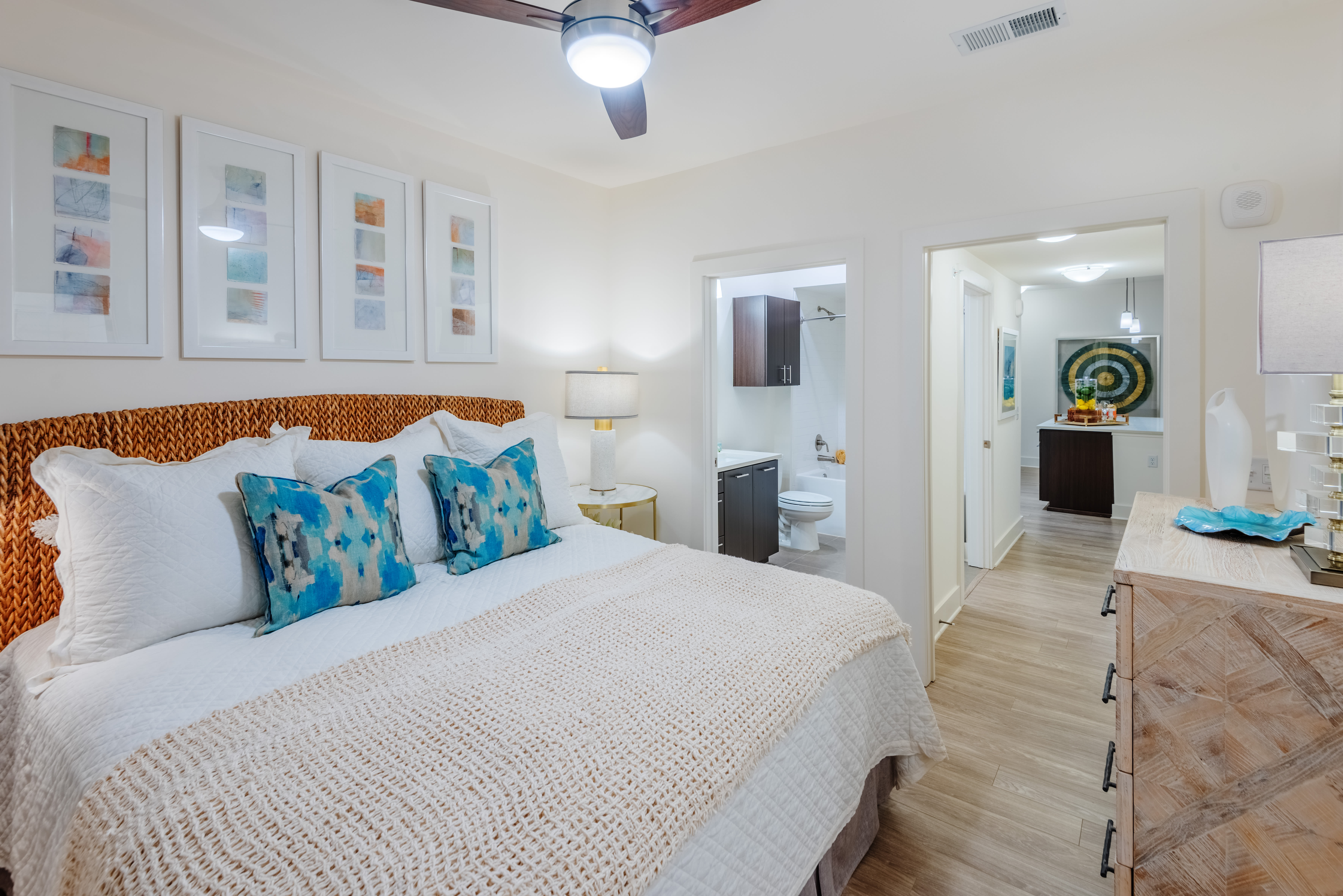 Bedroom with own bathroom, wood-style flooring, and ceiling fan at The Reverie At Lake Boone in Raleigh, North Carolina