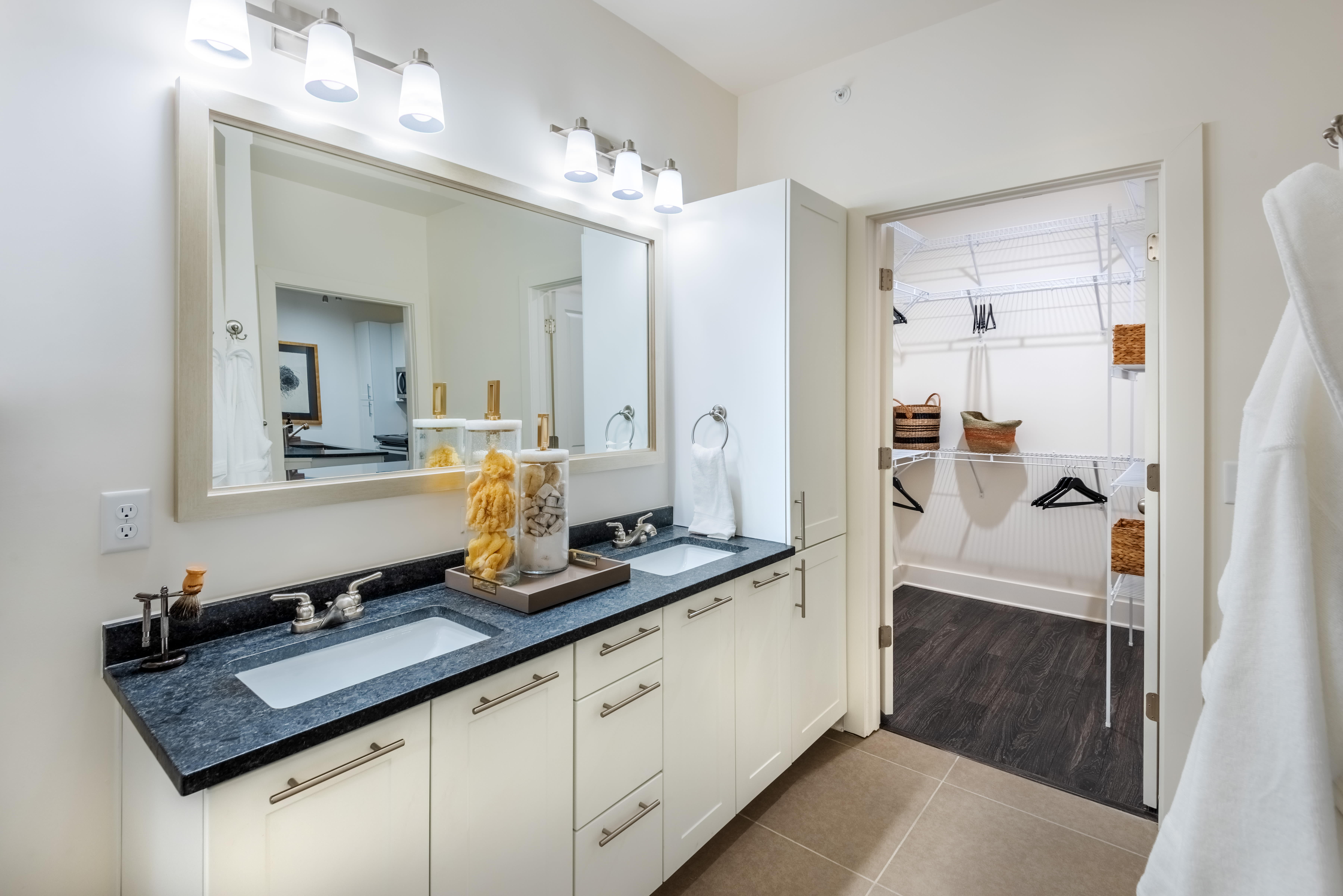 Bathroom with waterfall faucet sink, and storage space at The Reverie At Lake Boone in Raleigh, North Carolina