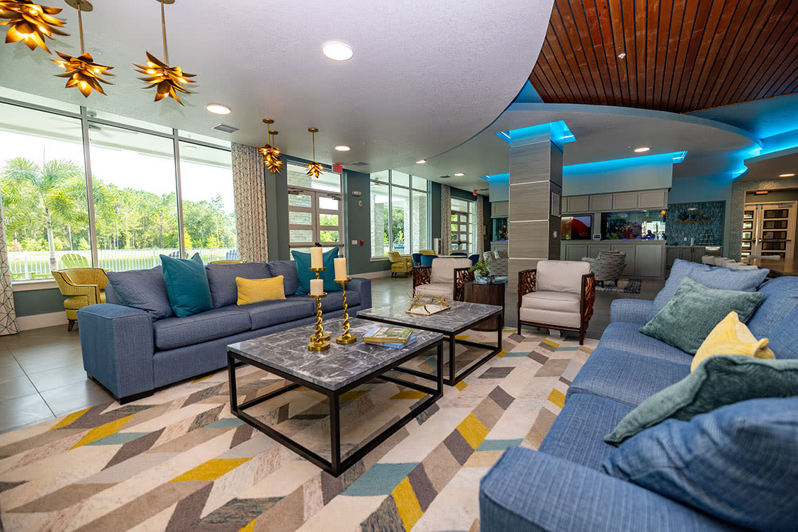 A furnished apartment living room and dining room at Mallory Square at Lake Nona in Orlando, Florida